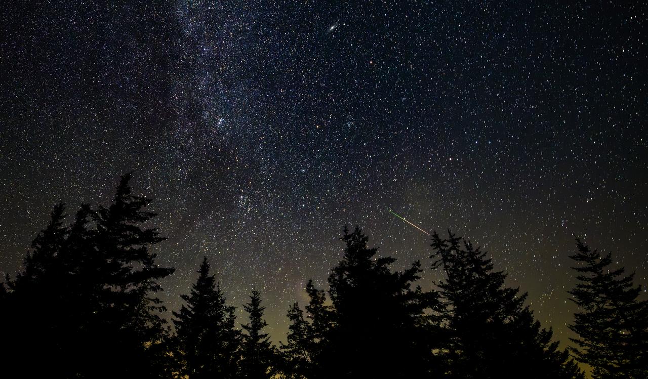 In this 30 second exposure photograph, a meteor streaks across the sky during the annual Perseid and Alpha Capricornids meteor showers, Sunday, Aug. 3, 2025, in Spruce Knob, West Virginia. Photo Credit: (NASA/Bill Ingalls)