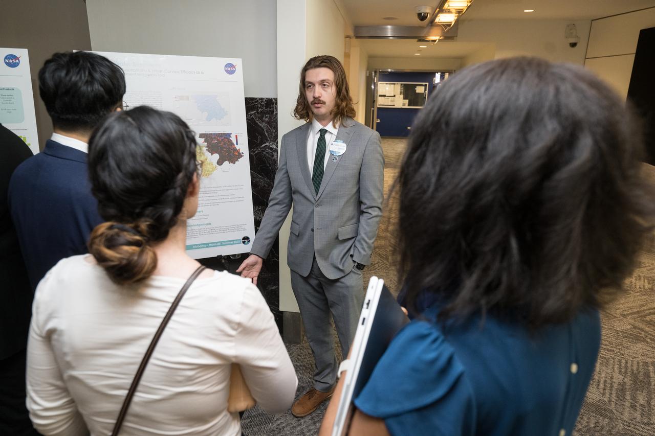 Students and young professionals share the results of their DEVELOP Project, Tuesday, August 5, 2025, at the Mary W. Jackson NASA Headquarters building in Washington. Every summer early career researchers from NASA’s DEVELOP National Program come to NASA Headquarters and present their research projects. DEVELOP is a training and development program where early career researchers work on Earth science projects, mentored by science advisors from NASA and partner agencies, and provide research results to local communities. Photo Credit: (NASA/Aubrey Gemignani)