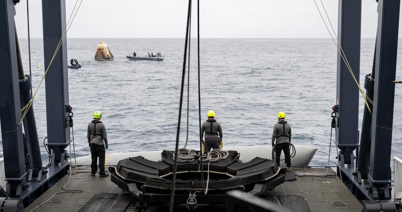 Support teams work around the SpaceX Dragon Endurance spacecraft shortly after it landed with NASA astronauts Anne McClain and Nichole Ayers, JAXA (Japan Aerospace Exploration Agency) astronaut Takuya Onishi, and Roscosmos cosmonaut Kirill Peskov aboard in the Pacific Ocean off the coast of San Diego, Calif., Saturday, Aug. 9,2025. McClain, Ayers, Onishi, and Peskov are returning after 147 days in space as part of Expedition 73 aboard the International Space Station. Photo Credit: (NASA/Keegan Barber)