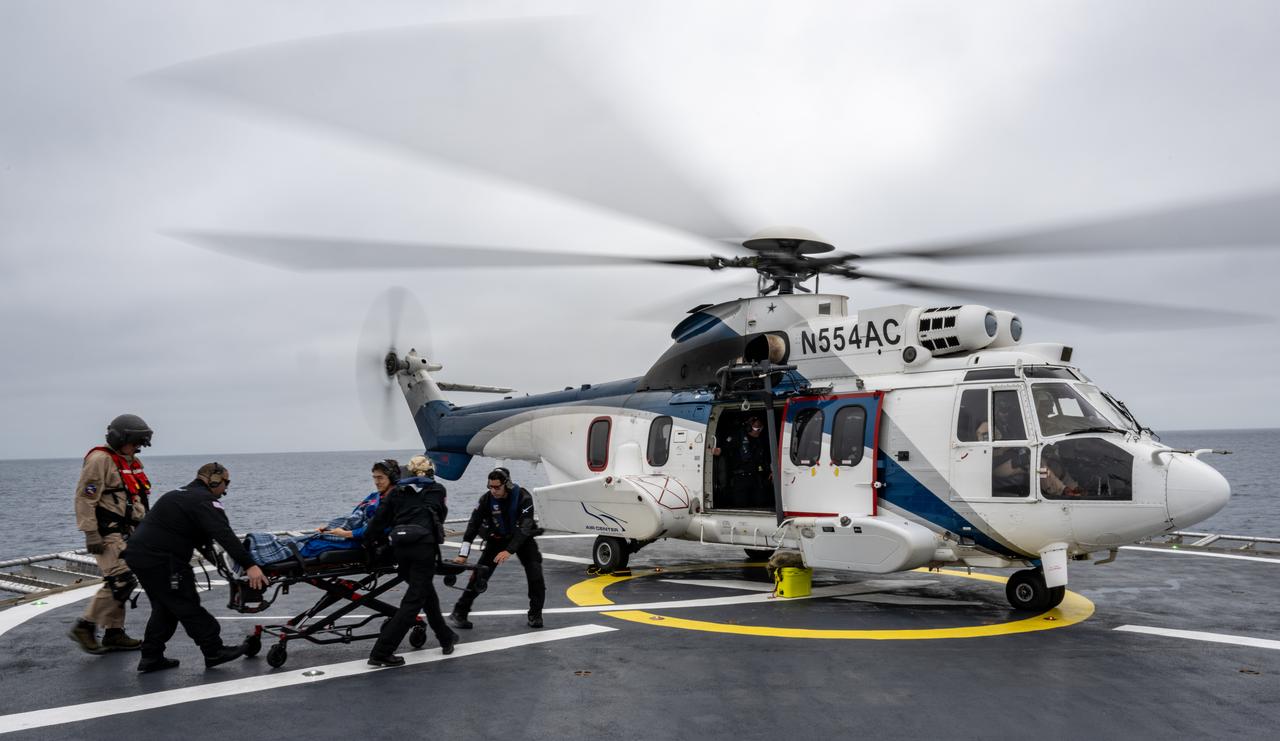 JAXA (Japan Aerospace Exploration Agency) astronaut Takuya Onishi is helped aboard a helicopter on the SpaceX recovery ship SHANNON to fly to Long Beach, Calif. along with NASA astronaut Nichole Ayers, Anne McClain, and Roscosmos cosmonaut Kirill Peskov shortly after they landed in the Pacific Ocean off the coast of San Diego, Calif., Saturday, Aug. 9, 2025. McClain, Ayers, Onishi, and Peskov are returning after 147 days in space as part of Expedition 73 aboard the International Space Station. Photo Credit: (NASA/Keegan Barber)