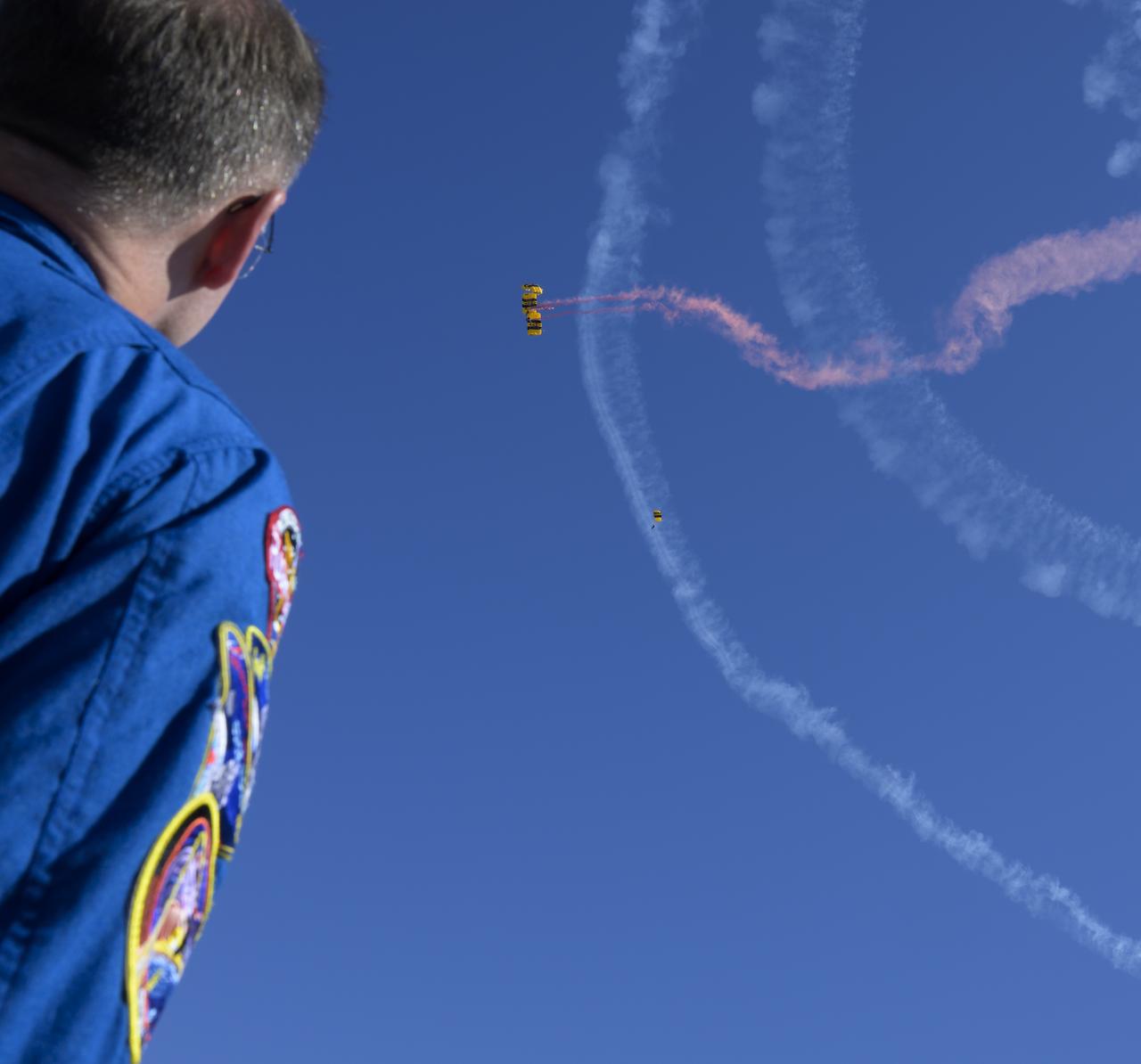 NASA astronaut Nick Hague watches as the United States Army Parachute Team, the Golden Knights, perform during the opening ceremony of the Joint Base Andrews Air Show, Friday, Sept. 12, 2025, at Joint Base Andrews in Prince George's County, Maryland. Hague spent 171 days onboard the International Space Station as part of Expedition 72. Photo Credit: (NASA/Bill Ingalls)
