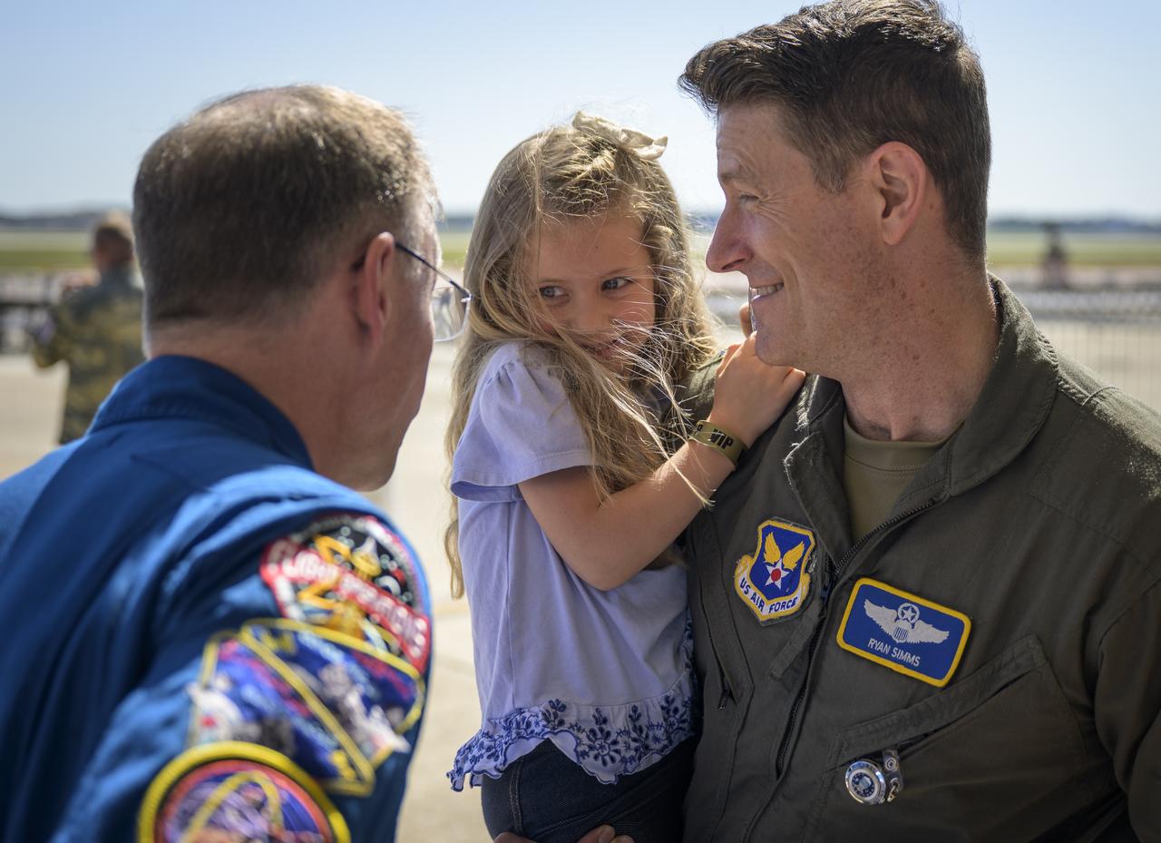 5-year old Vivian Simms, and her father Ryan Simms, meet with NASA astronaut Nick Hague, Friday, Sept. 12, 2025, during the Joint Base Andrews Air Show at Joint Base Andrews in Prince George's County, Maryland. Hague spent 171 days onboard the International Space Station as part of Expedition 72. Photo Credit: (NASA/Bill Ingalls)