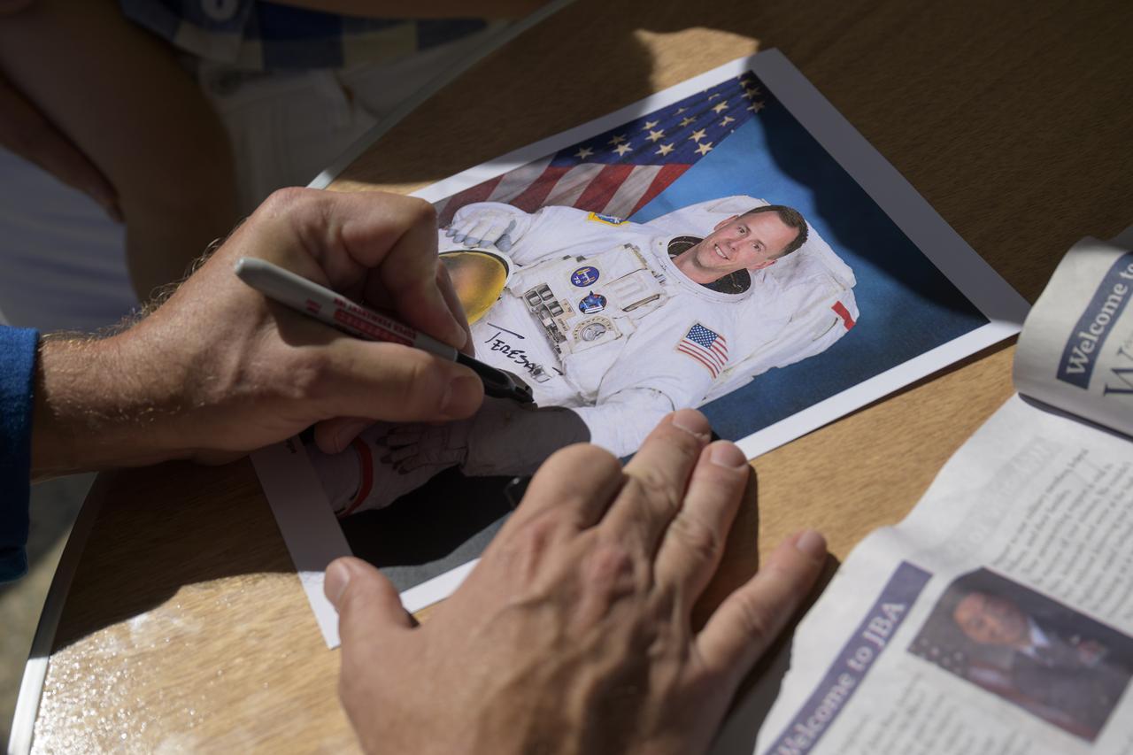 NASA astronaut Nick Hague signs autographs, Friday, Sept. 12, 2025, during the Joint Base Andrews Air Show at Joint Base Andrews in Prince George's County, Maryland. Hague spent 171 days onboard the International Space Station as part of Expedition 72. Photo Credit: (NASA/Bill Ingalls)