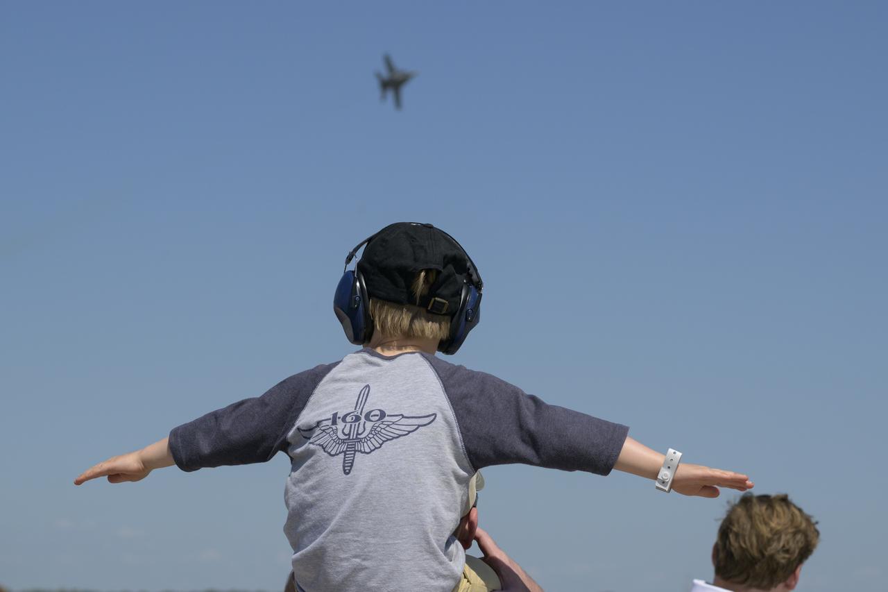 A young spectator watches a U.S. Navy F/A-15F Super Hornet jet fly, Friday, Sept. 12, 2025, during the Joint Base Andrews Air Show at Joint Base Andrews in Prince George's County, Maryland. NASA astronaut Nick Hague was on hand to provide remarks and meet with guests. Hague spent 171 days onboard the International Space Station as part of Expedition 72. Photo Credit: (NASA/Bill Ingalls)