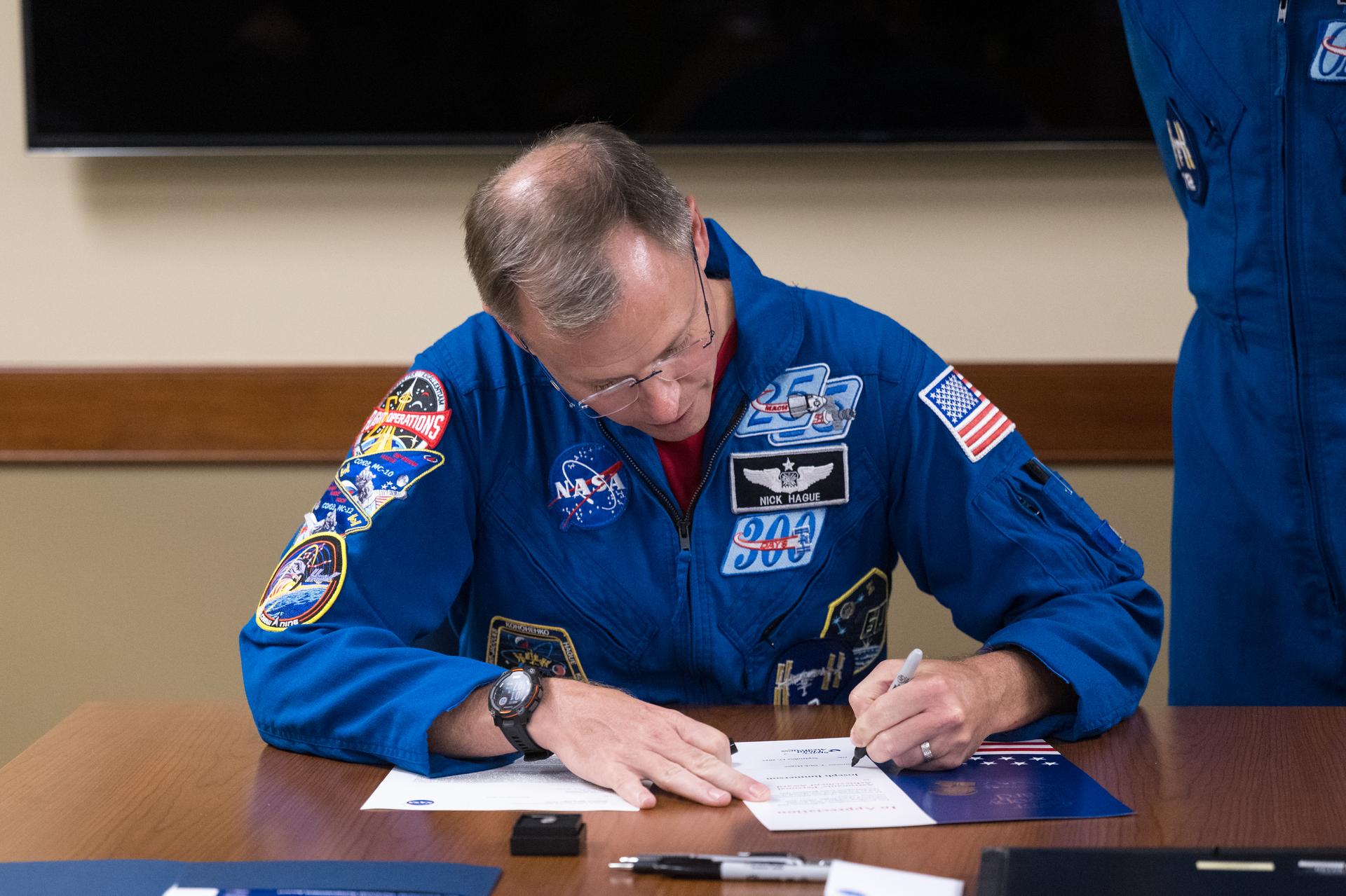 NASA astronaut Nick Hague signs a certificate and letter before a Silver Snoopy award presentation, Wednesday, Sept. 17, 2025, at NASA’s Goddard Space Flight Center in Greenbelt, Md. Hague served as part of Expedition 72 onboard the International Space Station. Photo Credit: (NASA/Aubrey Gemignani)