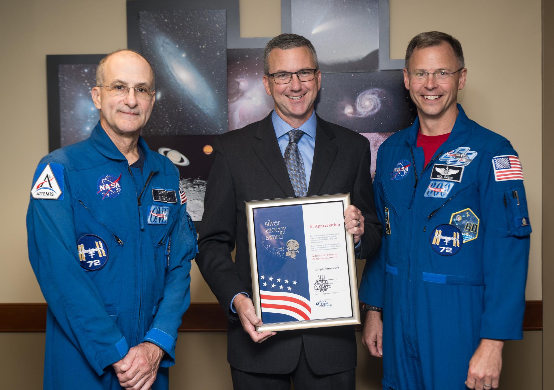 NASA astronauts Don Pettit, left, and Nick Hague, right, pose for a photo with NASA Range Operations Contract Engineer Manager at Wallops Flight Facility, Joseph Jimmerson, at his Silver Snoopy award presentation event, Wednesday, Sept. 17, 2025, at NASA’s Goddard Space Flight Center in Greenbelt, Md. Pettit and Hague served as part of Expedition 72 onboard the International Space Station. Photo Credit: (NASA/Aubrey Gemignani)