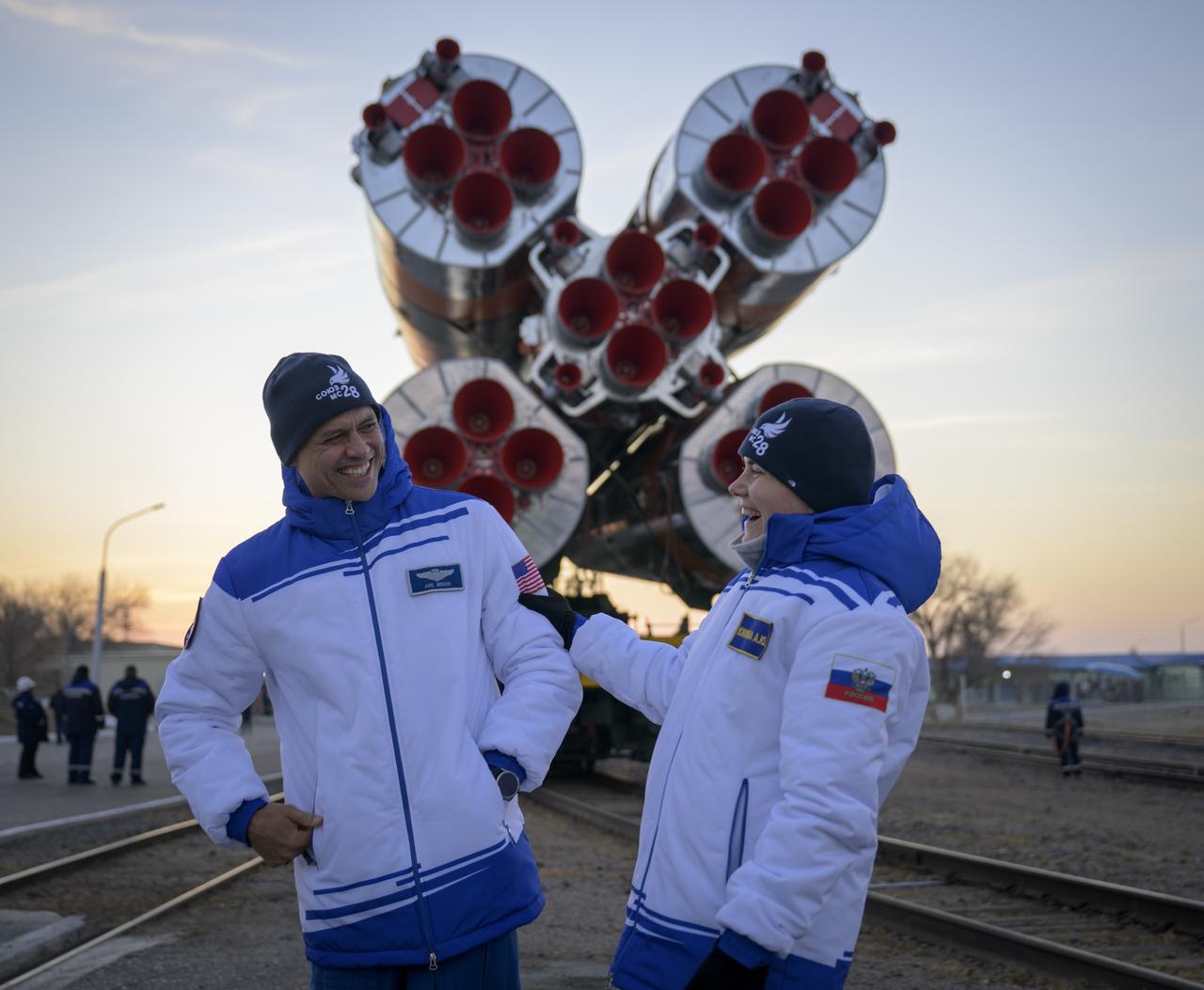 Expedition 74 backup crew members: Anna Kikina of Roscosmos, left, and Anil Menon of NASA, are seen as the Soyuz rocket is rolled out by train to the launch pad, Monday, Nov. 24, 2025, at Site 31 of the Baikonur Cosmodrome in Kazakhstan. Expedition 74 crewmembers: NASA astronaut Chris Williams, Roscosmos cosmonauts Sergey Kud-Sverchkov and Sergey Mikaev are scheduled to launch aboard their Soyuz MS-28 spacecraft on November 27. Photo Credit: (NASA/Bill Ingalls)