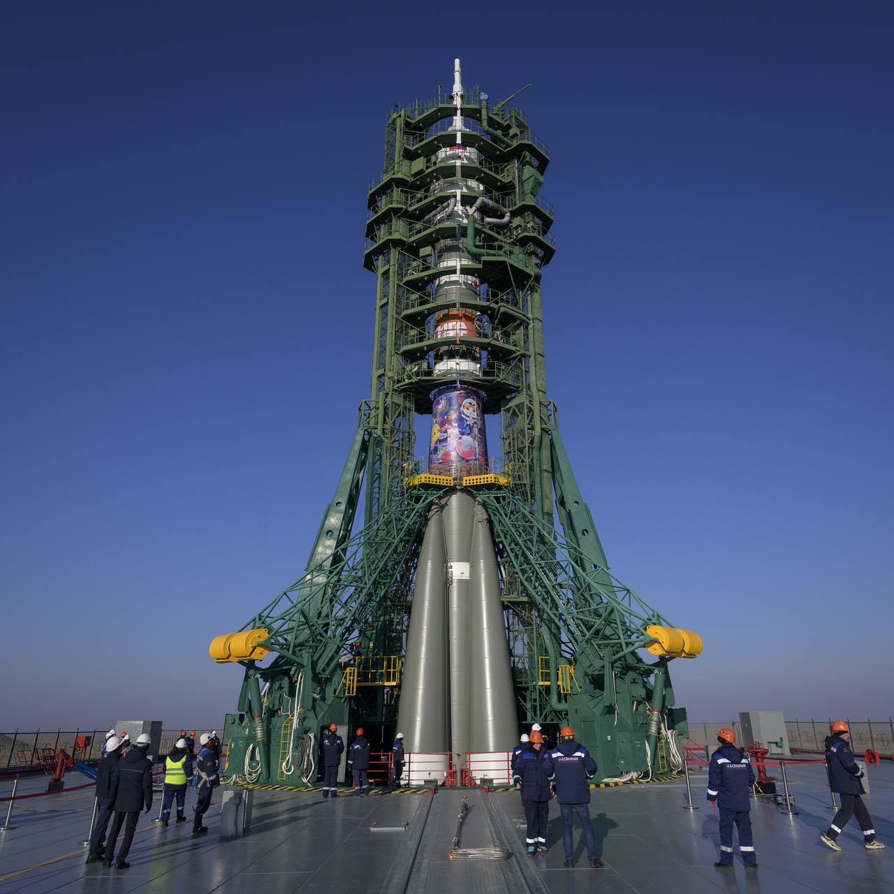 The Soyuz rocket is seen after having been rolled out by train to the launch pad, Monday, Nov. 24, 2025, at Site 31 of the Baikonur Cosmodrome in Kazakhstan. Expedition 74 crewmembers: NASA astronaut Chris Williams, Roscosmos cosmonauts Sergey Kud-Sverchkov and Sergey Mikaev are scheduled to launch aboard their Soyuz MS-28 spacecraft on November 27. Photo Credit: (NASA/Bill Ingalls)