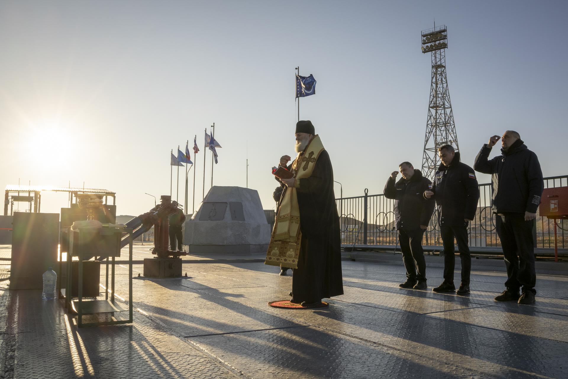 Russian Orthodox Priest blesses the Soyuz rocket, Wednesday, Nov. 26, 2025 at the Baikonur Cosmodrome in Kazakhstan. Expedition 74 crewmembers: NASA astronaut Chris Williams, Roscosmos cosmonauts Sergey Kud-Sverchkov and Sergei Mikaev, are scheduled to launch aboard their Soyuz MS-28 spacecraft on November 27. Photo Credit: (NASA/Victor Zelentsov)