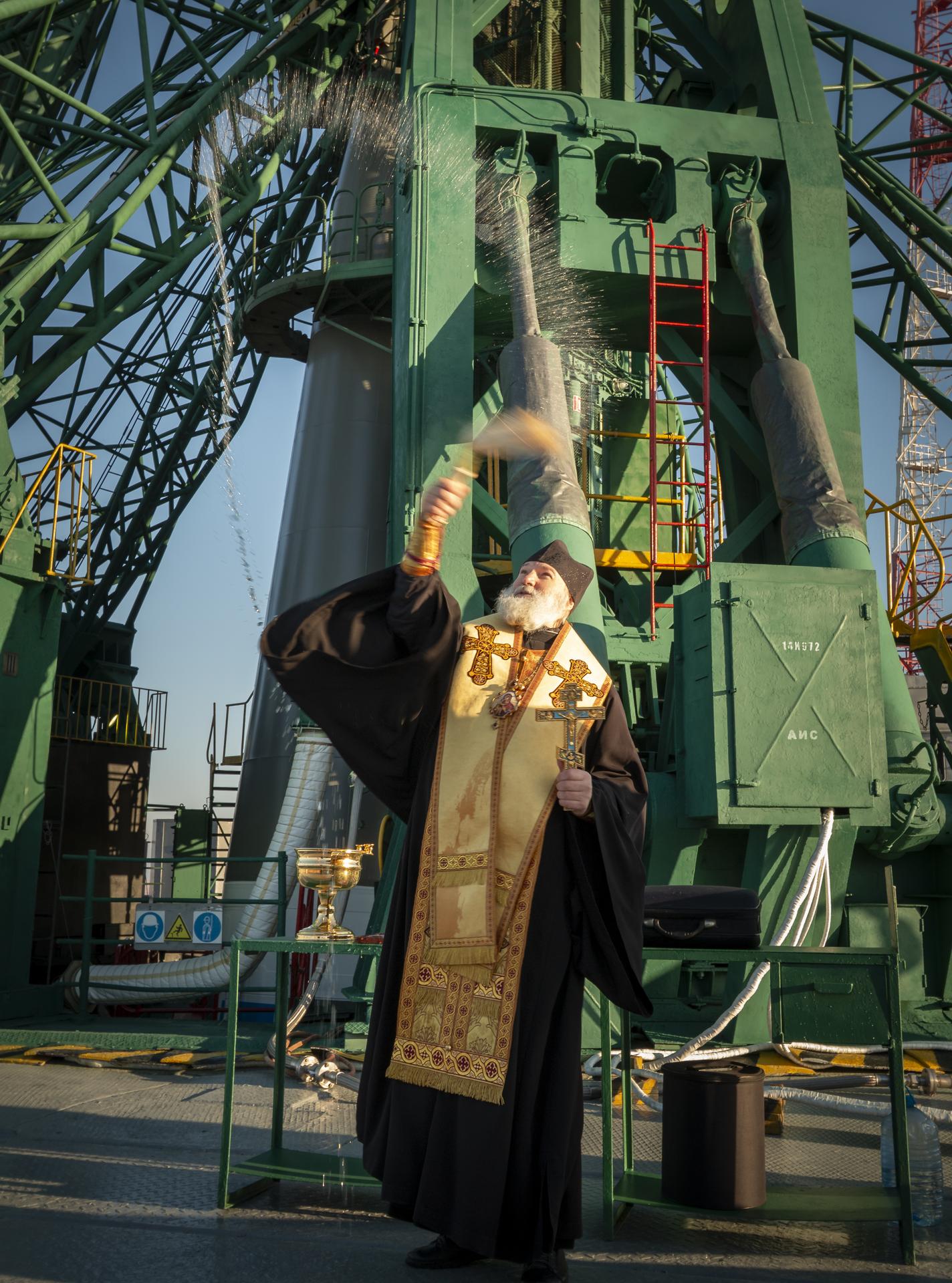 Russian Orthodox Priest blesses the Soyuz rocket, Wednesday, Nov. 26, 2025 at the Baikonur Cosmodrome in Kazakhstan. Expedition 74 crewmembers: NASA astronaut Chris Williams, Roscosmos cosmonauts Sergey Kud-Sverchkov and Sergei Mikaev, are scheduled to launch aboard their Soyuz MS-28 spacecraft on November 27. Photo Credit: (NASA/Victor Zelentsov)