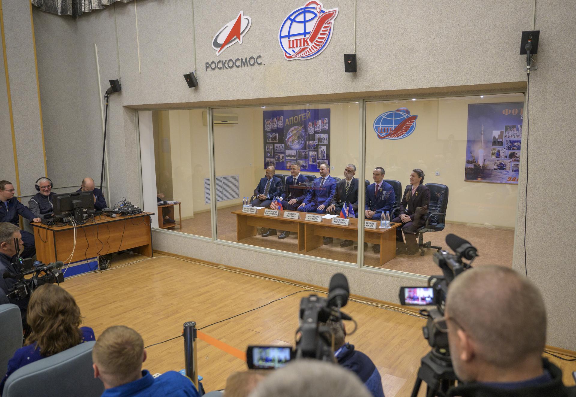 Expedition 74 crewmembers: NASA astronaut Chris Williams, left, Roscosmos cosmonauts Sergey Kud-Sverchkov and Sergei Mikaev, along with Expedition 74 backup crew members: Anil Menon of NASA, Petr Dubrov of Roscosmos, and Anna Kikina of Roscosmos, right, are seen during the State Commission meeting to approve the Soyuz launch of Expedition 74 to the International Space Station, Wednesday, Nov. 26, 2025 at the Cosmonaut Hotel in Baikonur, Kazakhstan. Williams, Kud-Sverchkov and Mikaev, are scheduled to launch aboard their Soyuz MS-28 spacecraft on November 27. Photo Credit: (NASA/Bill Ingalls)