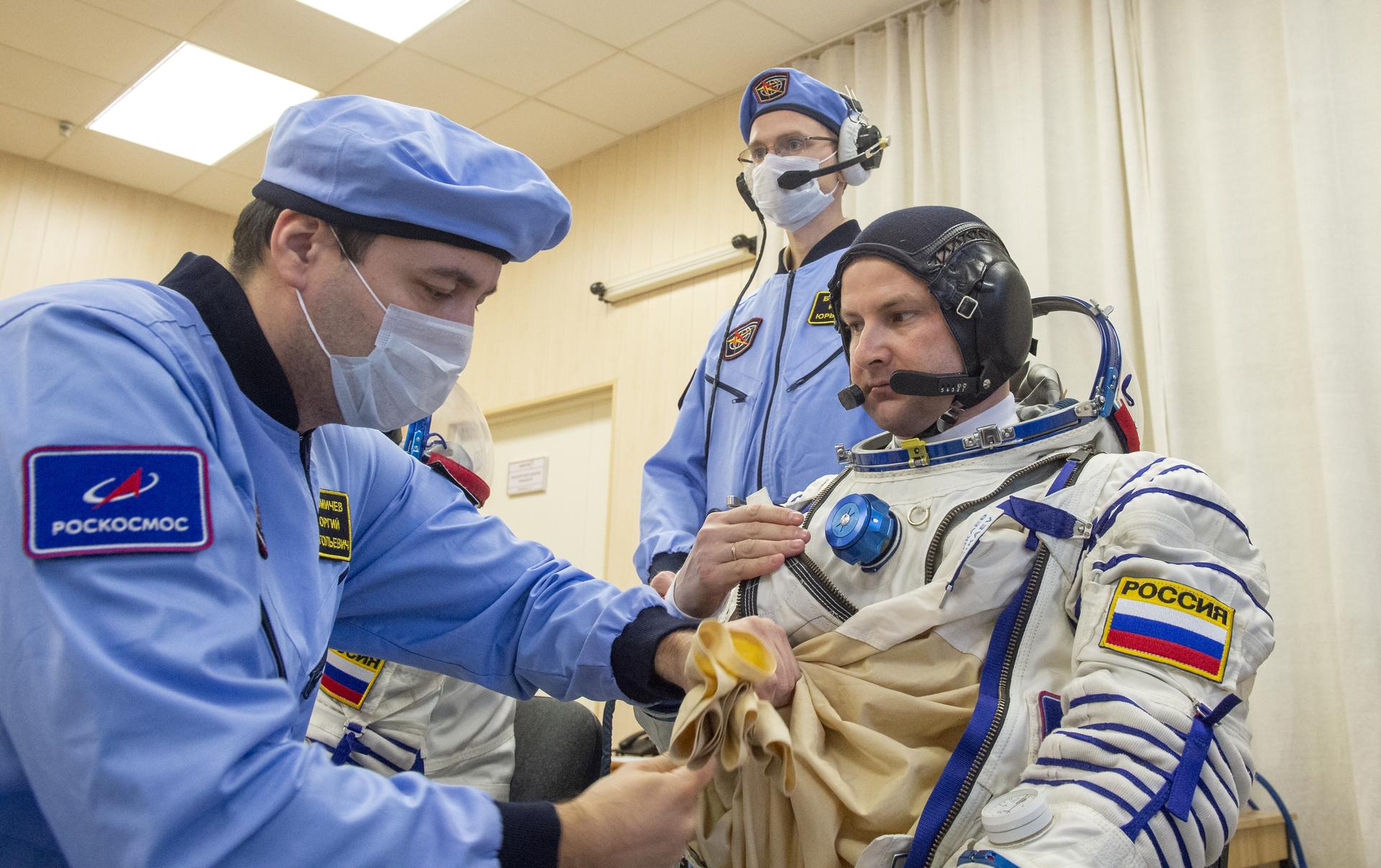 Roscosmos cosmonaut Sergei Mikaevis helped into his Russian Sokol suit as he and fellow crewmates, NASA astronaut Chris Williams, and Roscosmos cosmonaut Sergey Kud-Sverchkov, prepare for their Soyuz launch to the International Space Station Thursday, Nov. 27, 2025 in Baikonur, Kazakhstan. Photo Credit: (NASA/GCTC/Pavel Shvets)