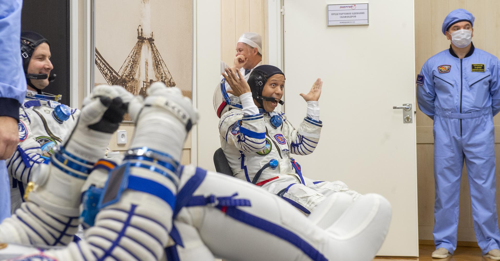 NASA astronaut Chris Williams interacts with his family as he waits to have his Russian Sokol suit pressure checked ahead of he and fellow crewmates, Roscosmos cosmonauts Sergey Kud-Sverchkov, and Sergei Mikaev, launch in their Soyuz MS-28 to the International Space Station Thursday, Nov. 27, 2025 in Baikonur, Kazakhstan. Photo Credit: (NASA/GCTC/Pavel Shvets)