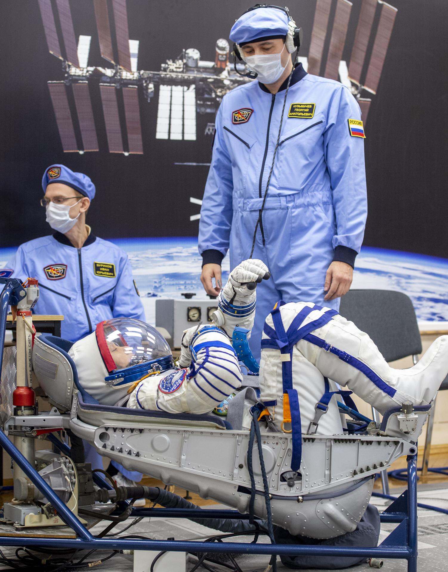 NASA astronaut Chris Williams has his Russian Sokol suit pressure checked as he and fellow crewmates, Roscosmos cosmonauts Sergei Mikaev, and Sergey Kud-Sverchkov, prepare for their Soyuz launch to the International Space Station Thursday, Nov. 27, 2025 in Baikonur, Kazakhstan. Photo Credit: (NASA/GCTC/Pavel Shvets)