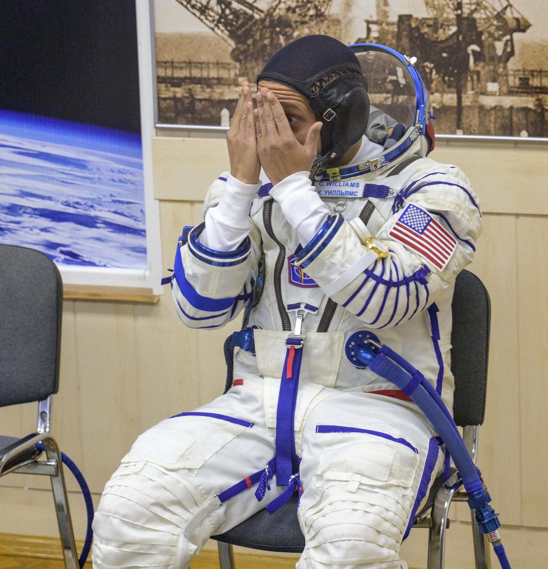 NASA astronaut Chris Williams interacts with his children as he waits to have his Russian Sokol suit pressure checked ahead of his launch on the Soyuz Rocket to the International Space Station with fellow crewmembers, Roscosmos cosmonauts Sergey Kud-Sverchkov, and Sergei Mikaev, Thursday, Nov. 27, 2025 in Baikonur, Kazakhstan. Photo Credit: (NASA/Bill Ingalls)