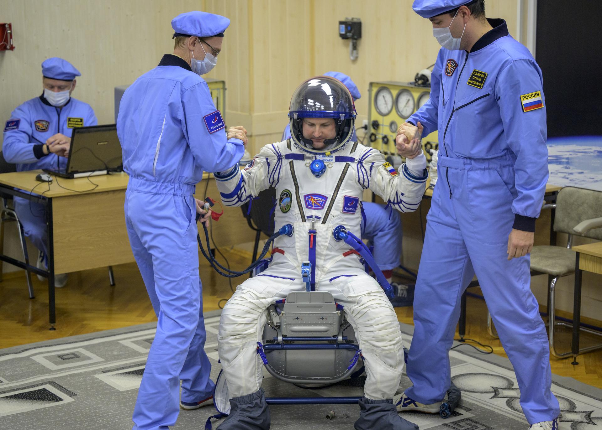 Roscosmos cosmonaut Sergei Mikaev has his Russian Sokol suit pressure checked as Roscosmos cosmonaut Sergey Kud-Sverchkov, and NASA astronaut Chris Williams, prepare to launch in the Soyuz rocket to the International Space Station Thursday, Nov. 27, 2025 in Baikonur, Kazakhstan. Photo Credit: (NASA/Bill Ingalls)