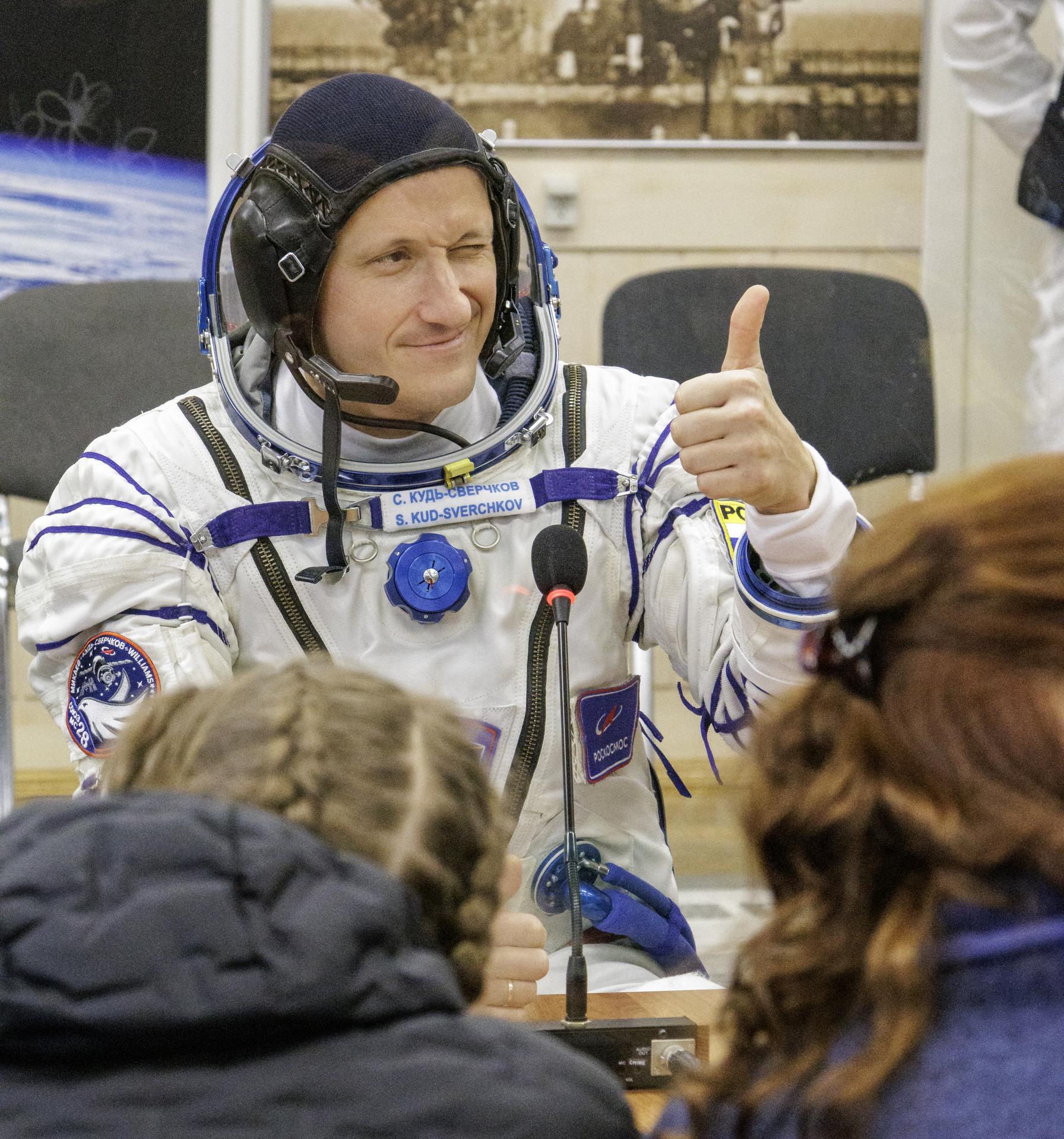 Roscosmos cosmonaut Sergey Kud-Sverchkov talks to his family after having his Russian Sokol suit pressured checked as he and crew mates, NASA astronaut Chris Williams, and Roscosmos cosmonaut Sergei Mikaev, prepare for their Soyuz launch to the International Space Station Thursday, Nov. 27, 2025 in Baikonur, Kazakhstan. Photo Credit: (NASA/Victor Zelentsov)