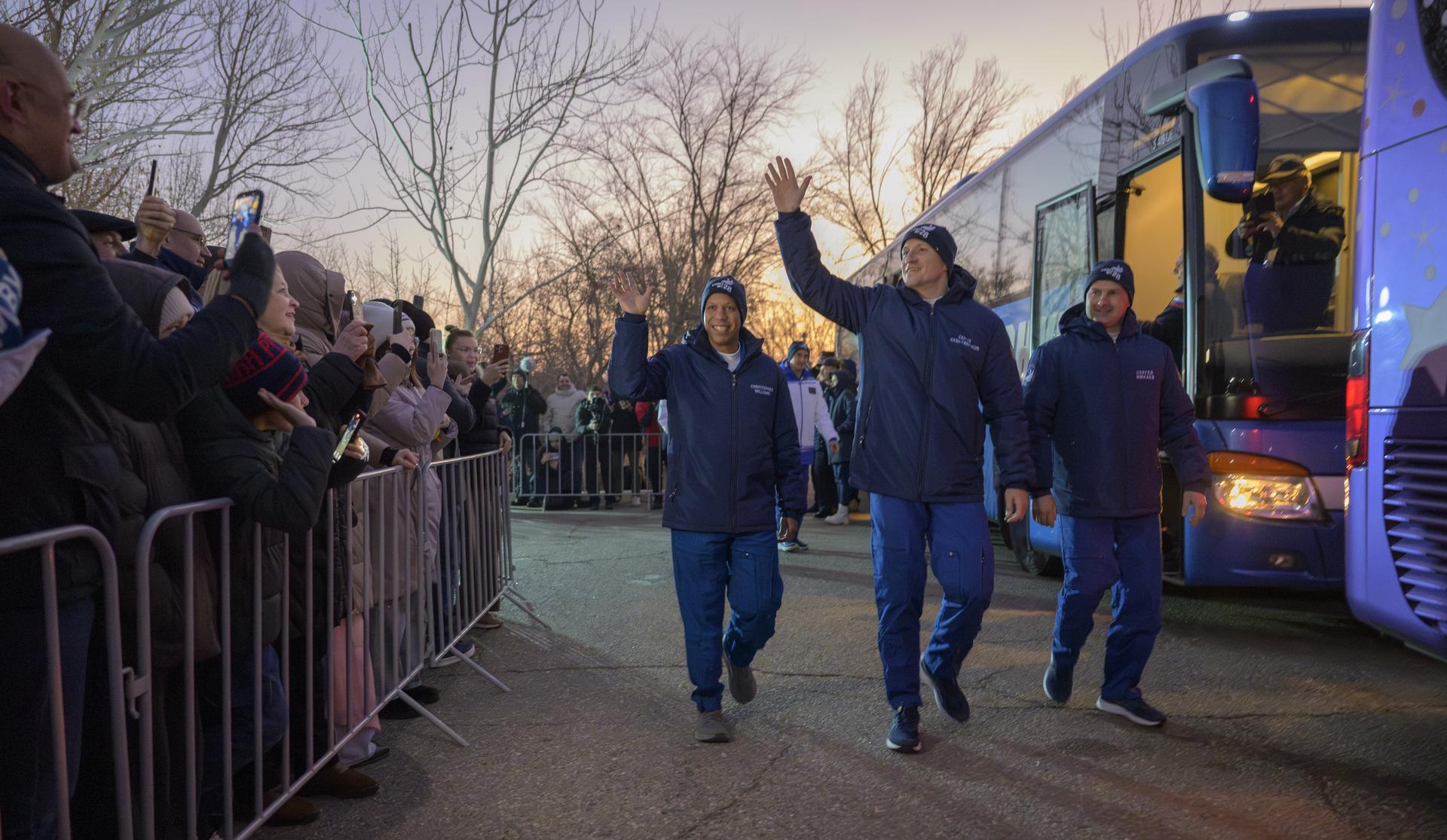 NASA astronaut Chris Williams, left, Roscosmos cosmonauts Sergey Kud-Sverchkov, and Sergei Mikaev, right, depart the Cosmonaut Hotel to suit-up for their Soyuz launch, Thursday, Nov. 27, 2025, in Baikonur, Kazakhstan. The launch will send Williams, Kud-Sverchkov and Mikaev, on a mission to the International Space Station. Photo Credit: (NASA/Bill Ingalls)