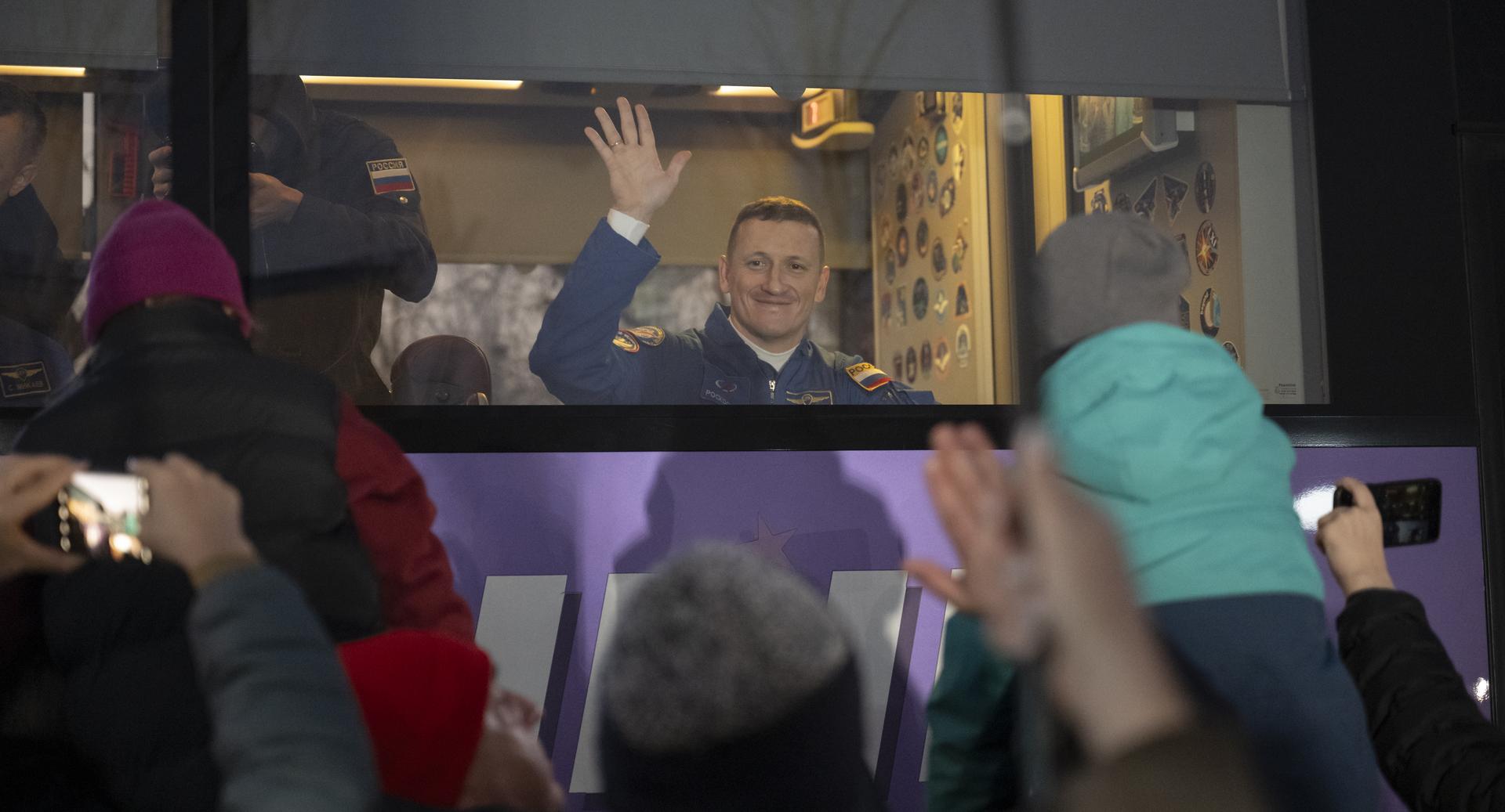 Roscosmos cosmonaut Sergey Kud-Sverchkov waves farewell, as he and fellow crewmembers, Roscosmos cosmonaut Sergei Mikaev, and NASA astronaut Chris Williams, depart the Cosmonaut Hotel to suit-up for their Soyuz launch, Thursday, Nov. 27, 2025, in Baikonur, Kazakhstan. The launch will send Williams, Kud-Sverchkov and Mikaev, on a mission to the International Space Station. Photo Credit: (NASA/Bill Ingalls)