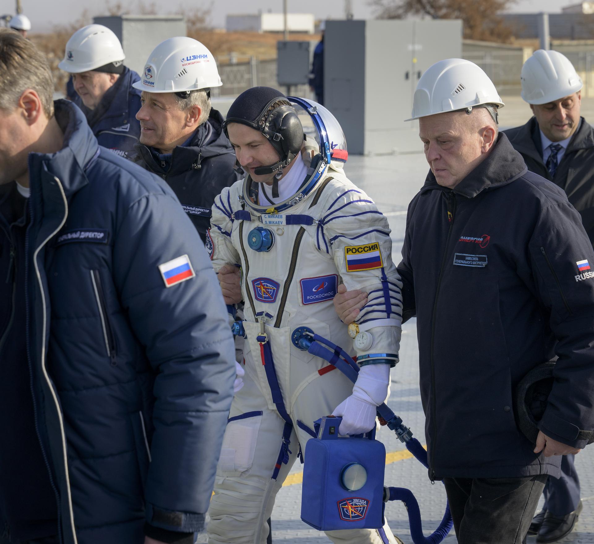 Roscosmos cosmonaut Sergei Mikaev walks to board the Soyuz rocket Thursday, Nov. 27, 2025 at the Baikonur Cosmodrome in Kazakhstan. Launch of the Soyuz rocket will send Mikaev, Roscosmos cosmonaut Sergey Kud-Sverchkov and NASA astronaut Chris Williams, on a mission to the International Space Station. Photo Credit: (NASA/Bill Ingalls)