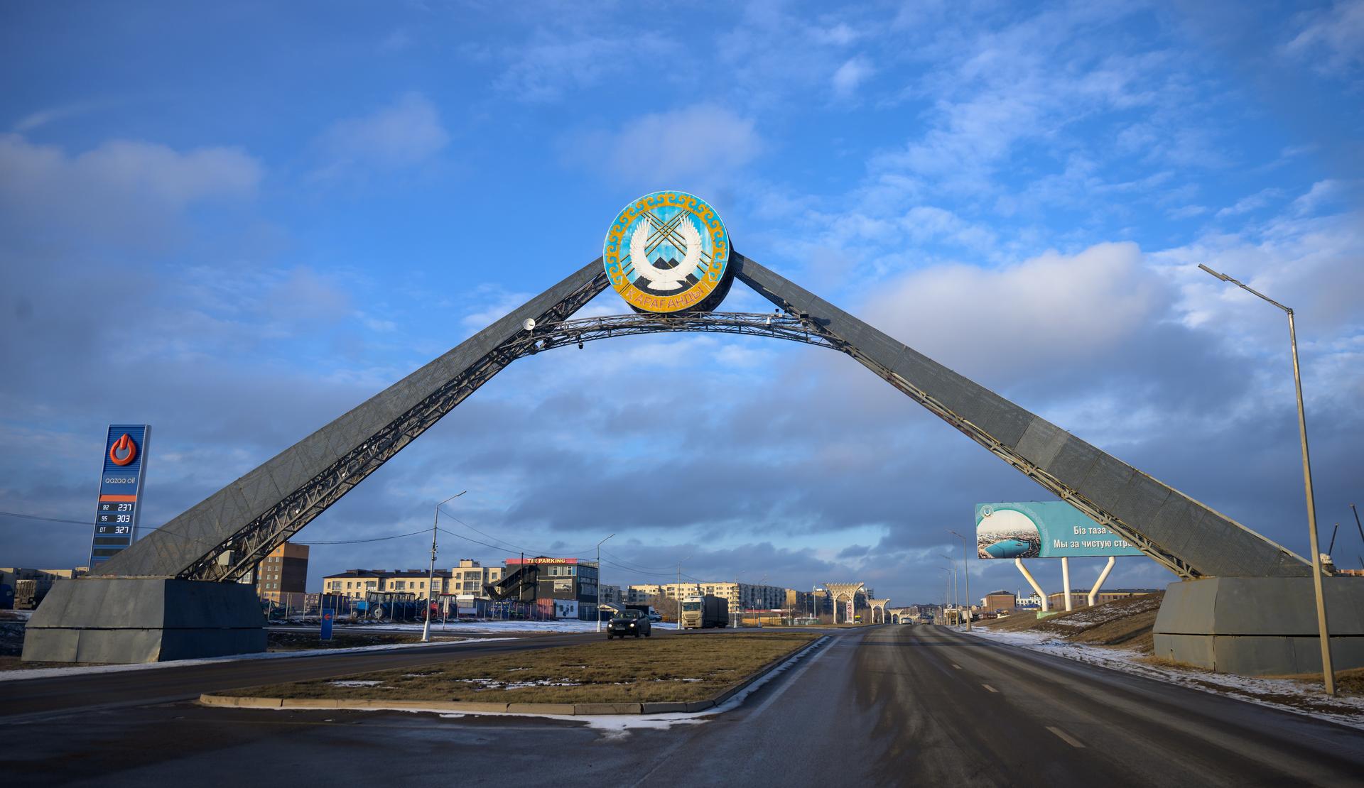 A sign at the entrance to Karaganda, Kazakhstan is seen as NASA, Roscosmos, and Russian Search and Recovery Forces arrive ahead of the landing of Expedition 73 NASA astronaut Jonny Kim, and Roscosmos cosmonauts Sergey Ryzhikov, and Alexey Zubritsky, Saturday, Dec. 6, 2025. The trio are returning to Earth after logging 245 days in space as a members of Expeditions 72 and 73 aboard the International Space Station. Photo Credit: (NASA/Bill Ingalls)