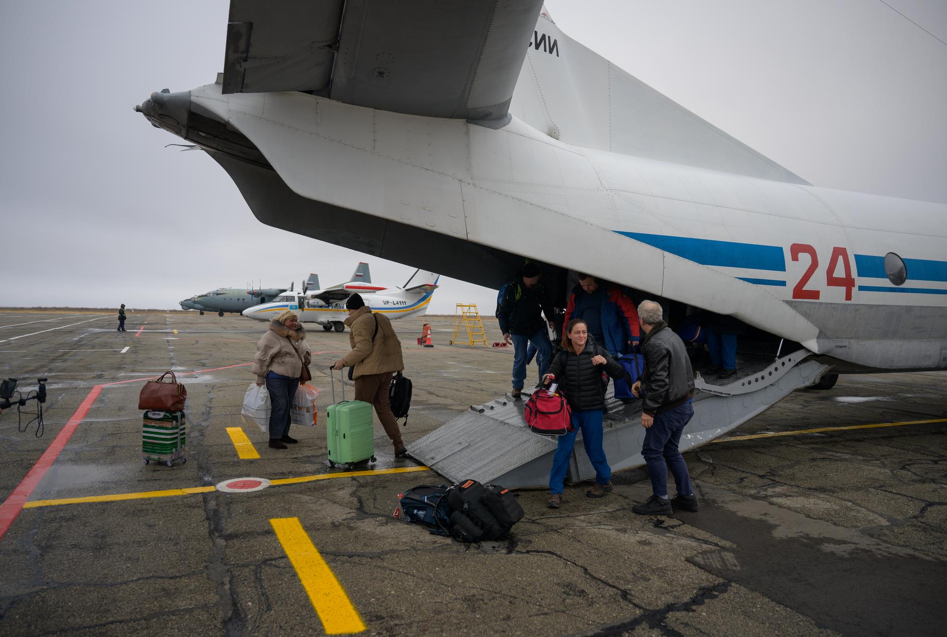 NASA, Roscosmos, and Russian Search and Recovery Forces arrive on an AN-26 plane in Zhezkazgan, Kazakhstan to prepare for the landing of Expedition 73 NASA astronaut Jonny Kim, and Roscosmos cosmonauts Sergey Ryzhikov, and Alexey Zubritsky, Monday, Dec. 8, 2025. The trio are returning to Earth after logging 245 days in space as a members of Expeditions 72 and 73 aboard the International Space Station. Photo Credit: (NASA/Bill Ingalls)