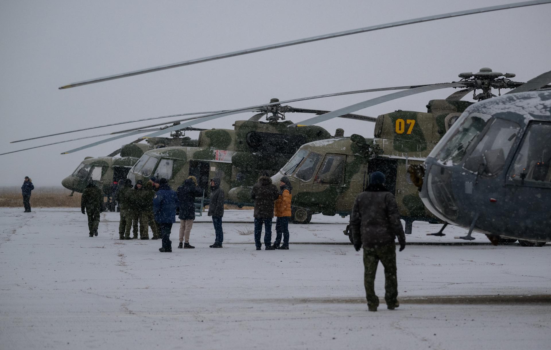 NASA, Roscosmos, and Russian Search and Recovery Forces prepare wait to board helicopters at the Zhezkazgan Airport in Kazakhstan to support the landing of Expedition 73 NASA astronaut Jonny Kim, and Roscosmos cosmonauts Sergey Ryzhikov, and Alexey Zubritsky, Tuesday, Dec. 9, 2025. The trio are returning to Earth after logging 245 days in space as a members of Expeditions 72 and 73 aboard the International Space Station. Photo Credit: (NASA/Bill Ingalls)