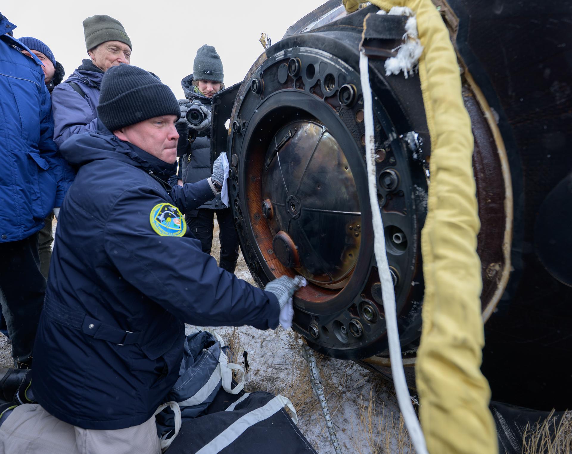 Russian Search and Rescue teams arrive at the Soyuz MS-27 spacecraft shortly after it landed in a remote area near the town of Zhezkazgan, Kazakhstan with Expedition 73 NASA astronaut Jonny Kim, and Roscosmos cosmonauts Sergey Ryzhikov, and Alexey Zubritsky aboard, Tuesday, Dec. 9, 2025. The trio returned to Earth after logging 245 days in space as a members of Expeditions 72 and 73 aboard the International Space Station. Photo Credit: (NASA/Bill Ingalls)