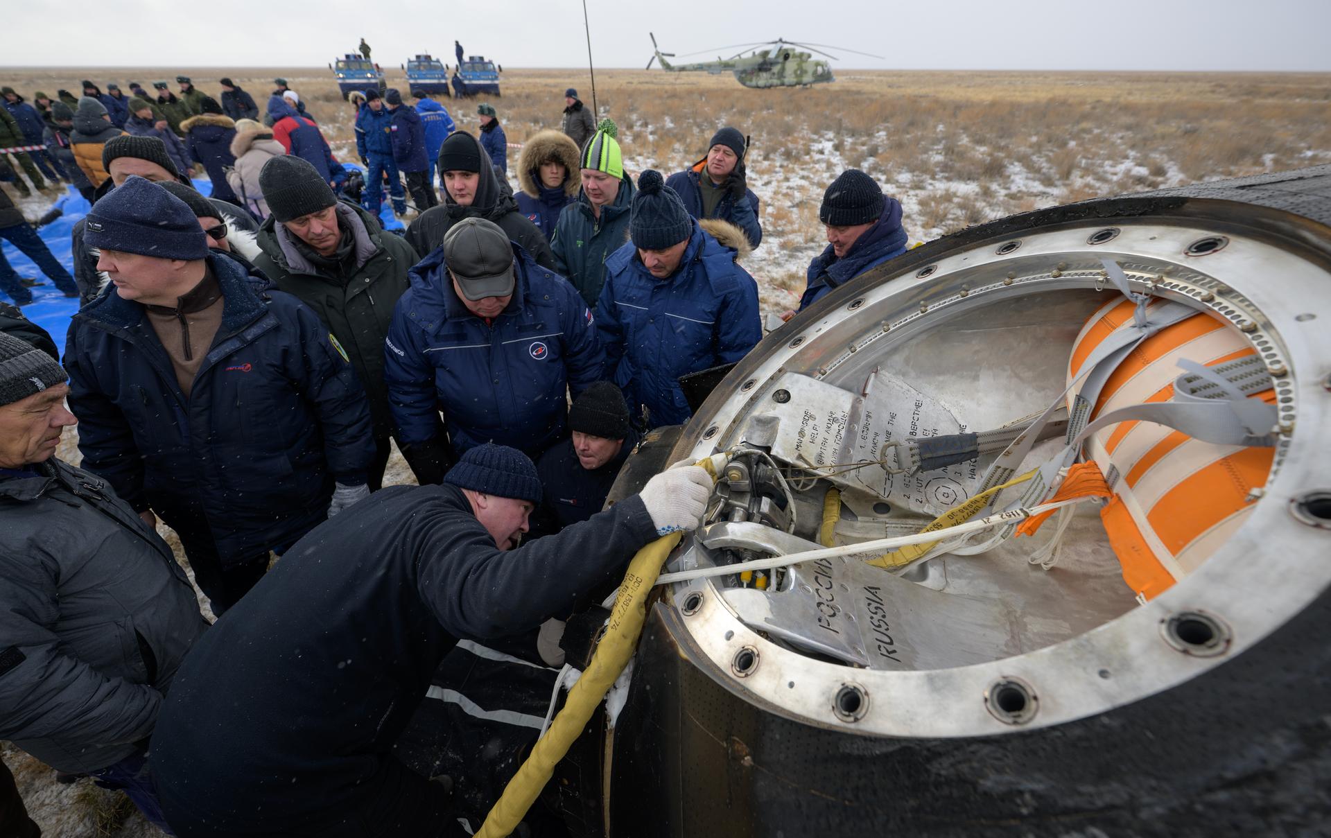 Russian Search and Rescue teams arrive at the Soyuz MS-27 spacecraft shortly after it landed in a remote area near the town of Zhezkazgan, Kazakhstan with Expedition 73 NASA astronaut Jonny Kim, and Roscosmos cosmonauts Sergey Ryzhikov, and Alexey Zubritsky aboard, Tuesday, Dec. 9, 2025. The trio returned to Earth after logging 245 days in space as a members of Expeditions 72 and 73 aboard the International Space Station. Photo Credit: (NASA/Bill Ingalls)