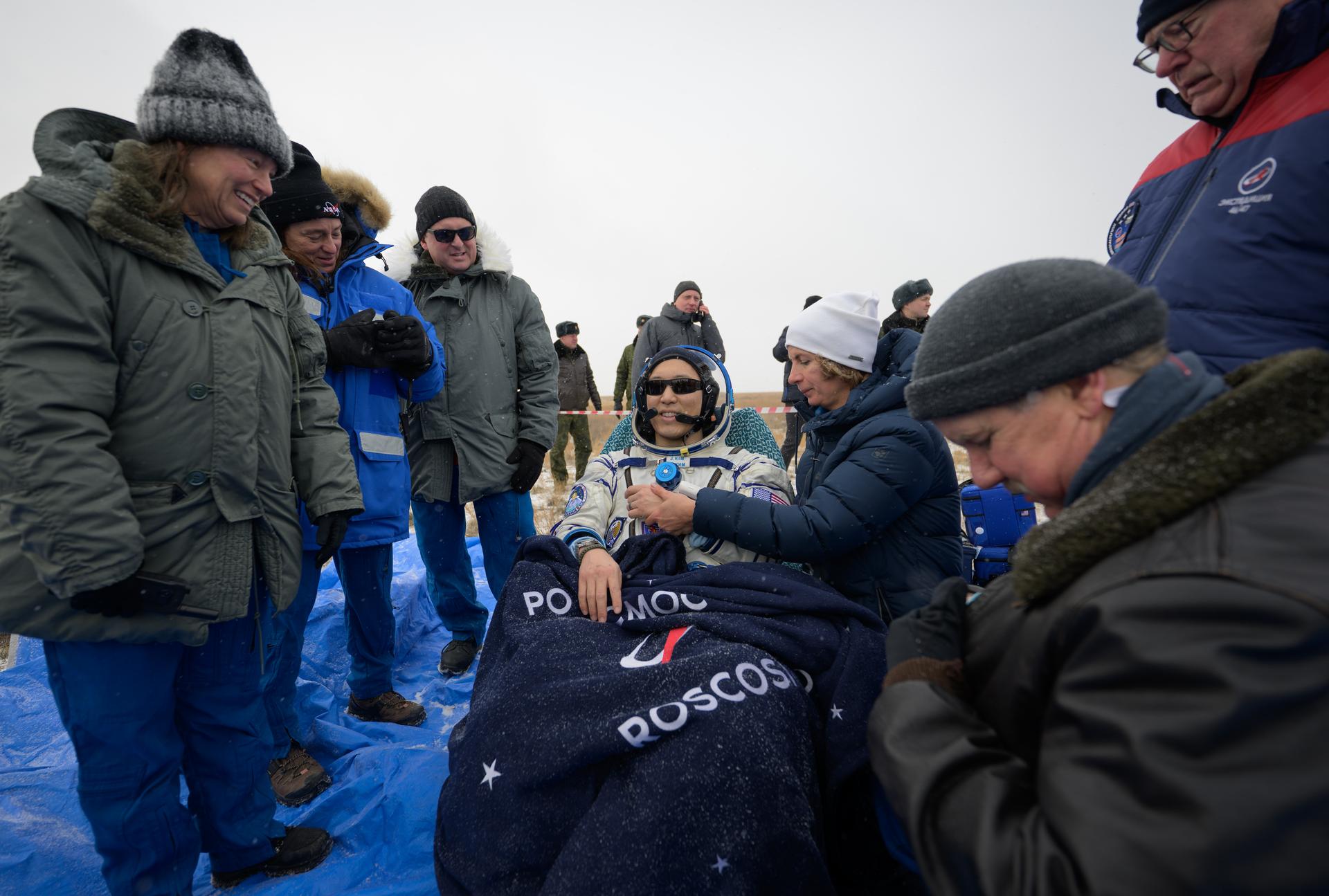 NASA astronaut Jonny Kim rest in a chair outside the Soyuz MS-27 spacecraft after he landed with Roscosmos cosmonauts Sergey Ryzhikov, and Alexey Zubritsky in a remote area near the town of Zhezkazgan, Kazakhstan on Tuesday, Dec. 9, 2025. The trio returned to Earth after logging 245 days in space as a members of Expeditions 72 and 73 aboard the International Space Station. Photo Credit: (NASA/Bill Ingalls)