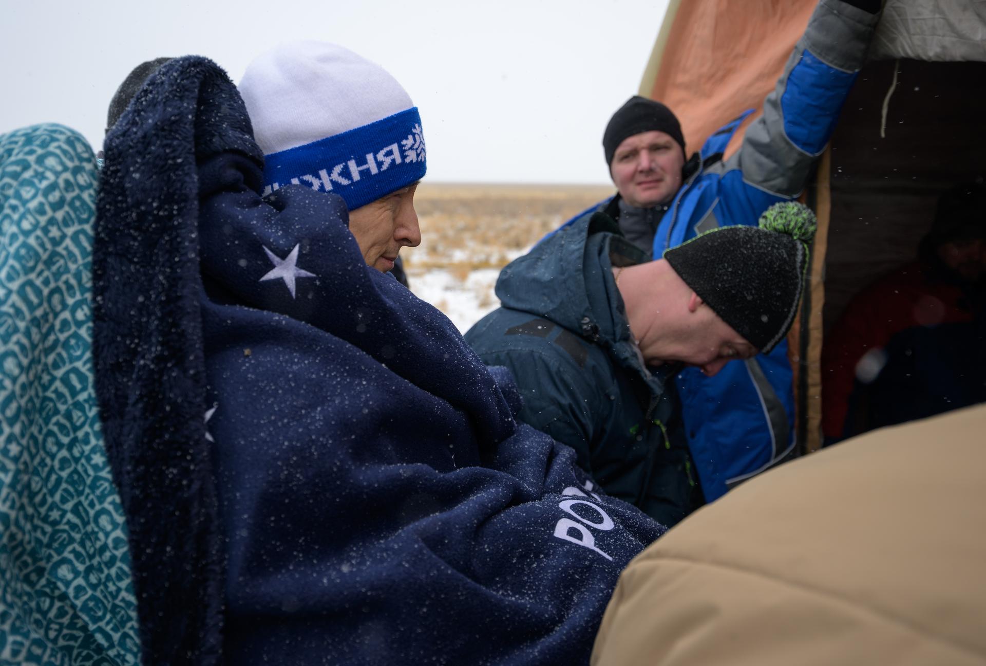Roscosmos cosmonaut Sergey Ryzhikov is carried to a medical tent shortly after he, NASA astronaut Jonny Kim, and Roscosmos cosmonaut Alexey Zubritsky, landed in their Soyuz MS-27 spacecraft near the town of Zhezkazgan, Kazakhstan on Tuesday, Dec. 9, 2025. The trio returned to Earth after logging 245 days in space as a members of Expeditions 72 and 73 aboard the International Space Station. Photo Credit: (NASA/Bill Ingalls)