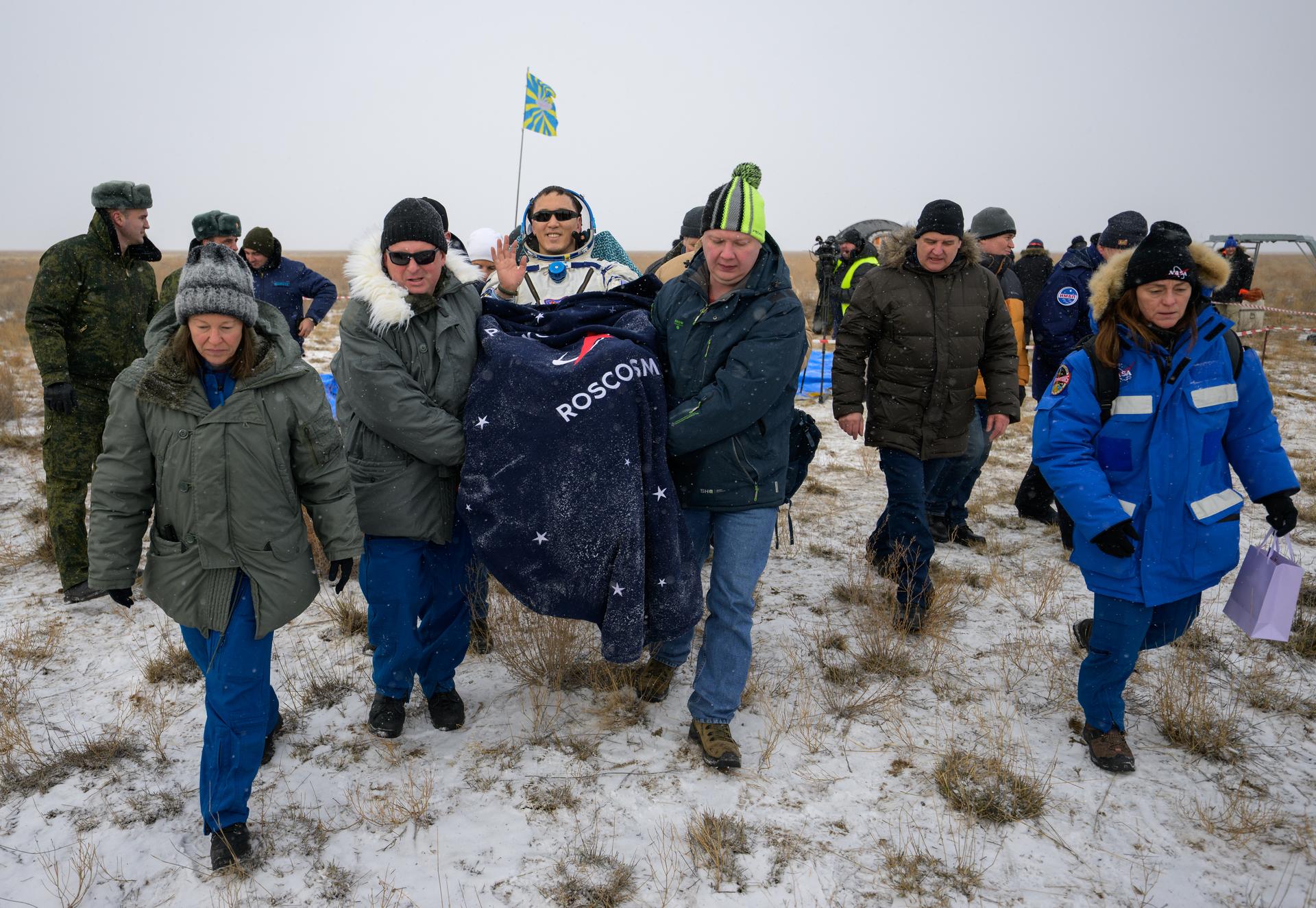 NASA astronaut Jonny Kim is carried to a medical tent shortly after he, and Roscosmos cosmonauts Sergey Ryzhikov, and Alexey Zubritsky, landed in their Soyuz MS-27 spacecraft near the town of Zhezkazgan, Kazakhstan on Tuesday, Dec. 9, 2025. The trio returned to Earth after logging 245 days in space as a members of Expeditions 72 and 73 aboard the International Space Station. Photo Credit: (NASA/Bill Ingalls)