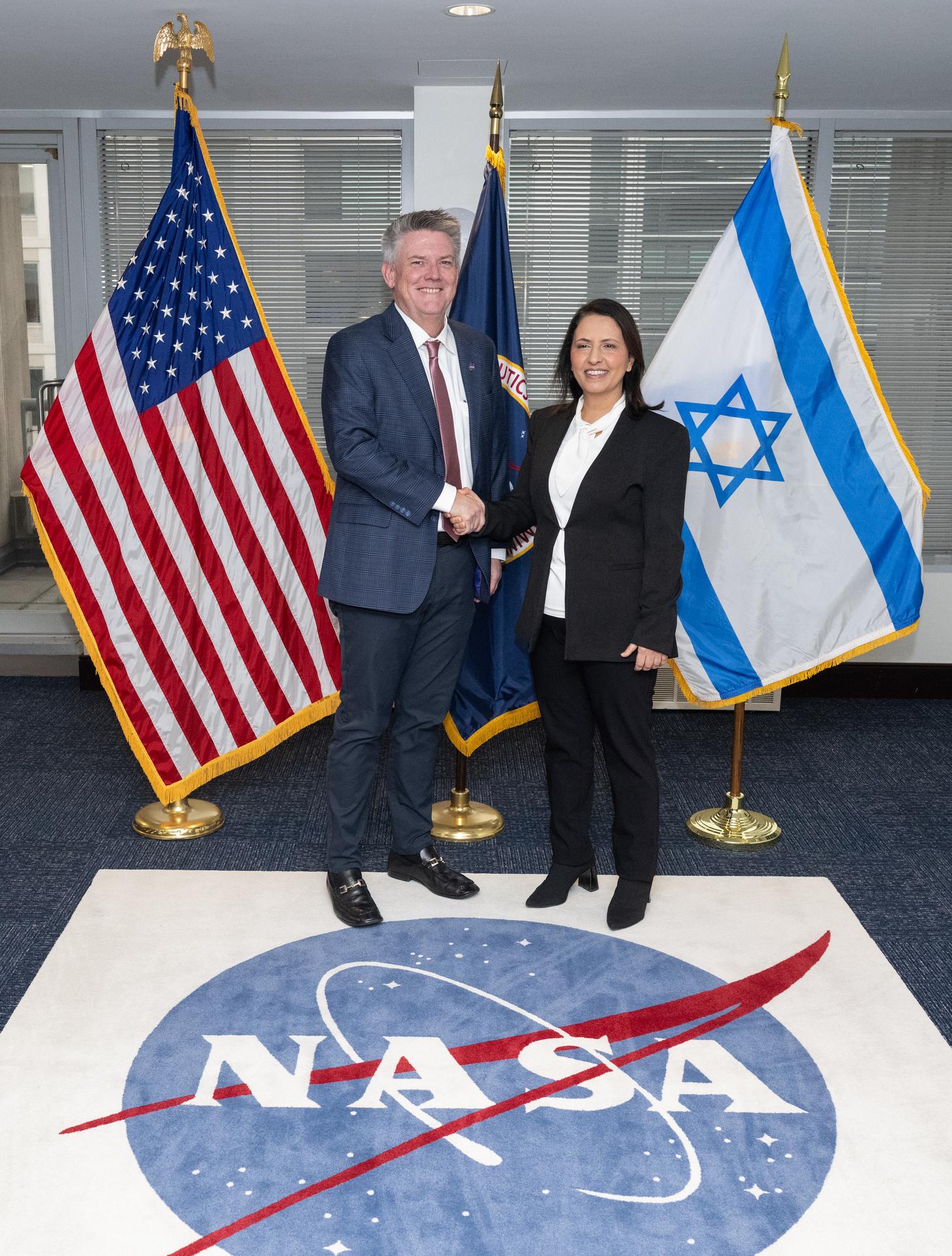 NASA Chief of Staff Brian Hughes, left, and Israel’s Minister for Innovation, Science, and Technology Gila Gamliel shake hands as they pose for a picture, Wednesday, Dec. 10, 2025, during a meeting at the Mary W. Jackson NASA Headquarters building in Washington. Photo Credit: (NASA/Joel Kowsky)