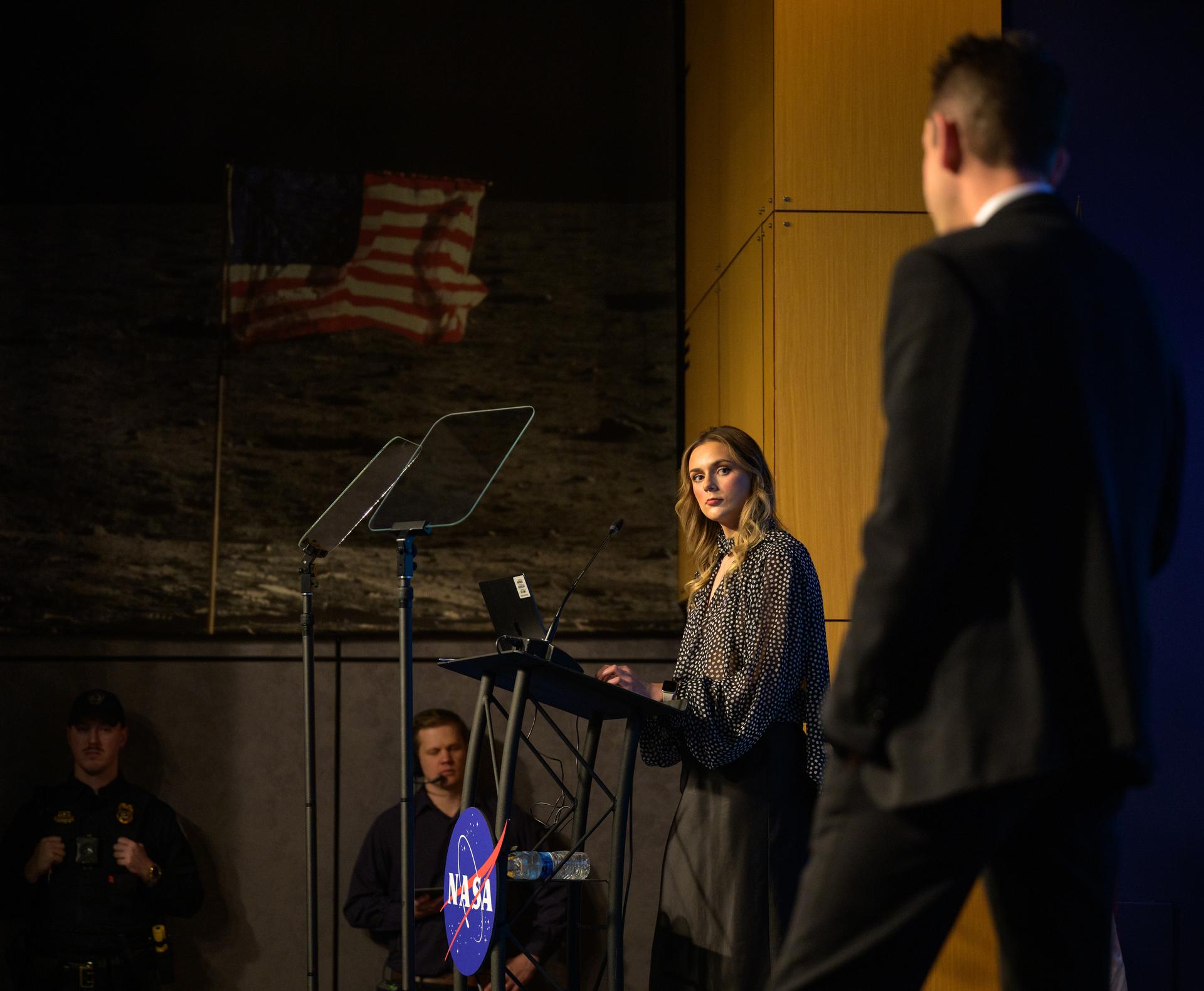 NASA Press Secretary Bethany Stevens listens as NASA Administrator Jared Isaacman responds to employee questions during an agency town hall, Friday, Dec. 19, 2025, at the Mary W. Jackson NASA Headquarters Building in Washington. Photo Credit: (NASA/Bill Ingalls)