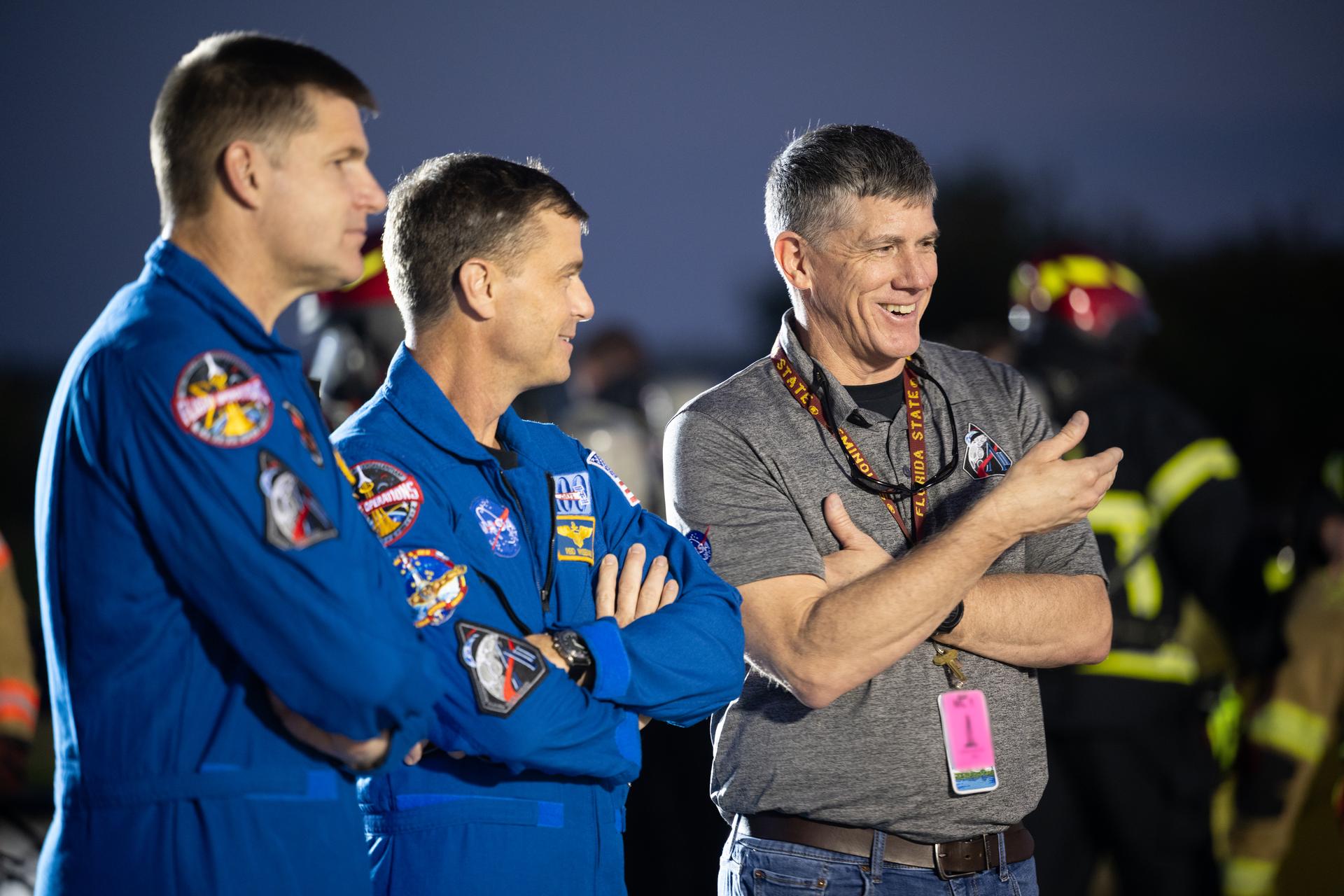 Jeremy Graeber, Artemis II Assistant Launch Director, talks with NASA astronaut Reid Wiseman, Artemis II commander, and CSA (Canadian Space Agency) astronaut Jeremy Hansen, Artemis II mission specialist, as teams at NASA's Kennedy Space Center in Florida practiced various emergency rescue training scenarios with the Artemis II crew, Friday, Dec. 19, 2025, ahead of the Artemis II mission. In the unlikely event of an emergency during launch countdown at Launch Complex 39B, personnel will be transported in mine-resistant ambush protected vehicles, or MRAPS, from the pad and to one of the triage site locations at Kennedy. Photo Credit: (NASA/Joel Kowsky)   NOTE - Portions of this image have been blurred for security reasons.