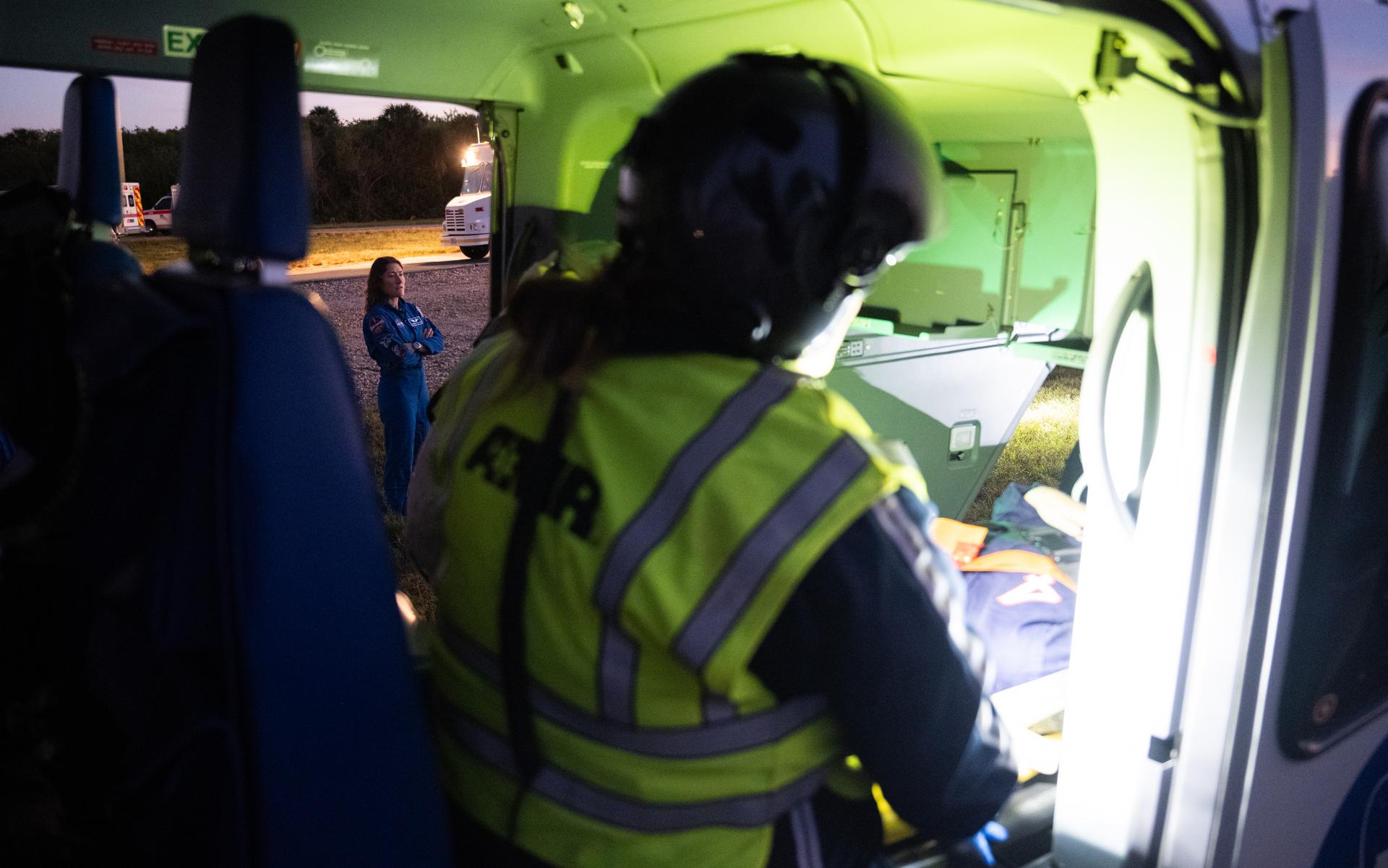 NASA astronaut Christina Koch, Artemis II mission specialist, looks on as teams at NASA's Kennedy Space Center in Florida practiced various emergency rescue training scenarios with the Artemis II crew, Friday, Dec. 19, 2025, ahead of the Artemis II mission. In the unlikely event of an emergency during launch countdown at Launch Complex 39B, personnel will be transported in mine-resistant ambush protected vehicles, or MRAPS, from the pad and to one of the triage site locations at Kennedy. Photo Credit: (NASA/Joel Kowsky)