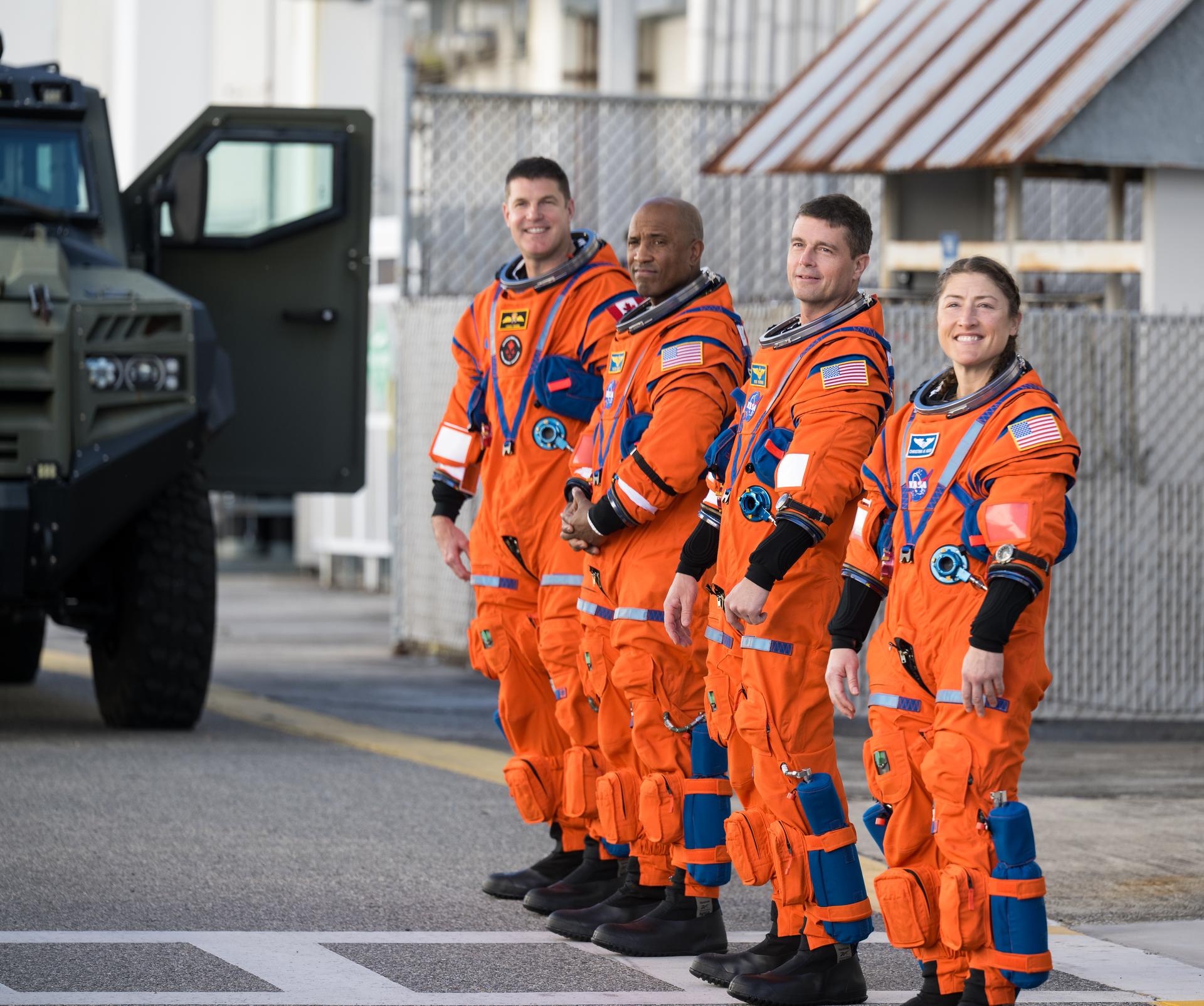 Image shows the Artemis II astronauts in their orange flight suits during a countdown test demonstration at NASA's Kennedy Space Center in Florida on Saturday, Dec. 20, 2025. From right to left, NASA astronauts Christina Koch, mission specialist; Reid Wiseman, commander; Victor Glover, pilot; and CSA (Canadian Space Agency) astronaut Jeremy Hansen, mission specialist