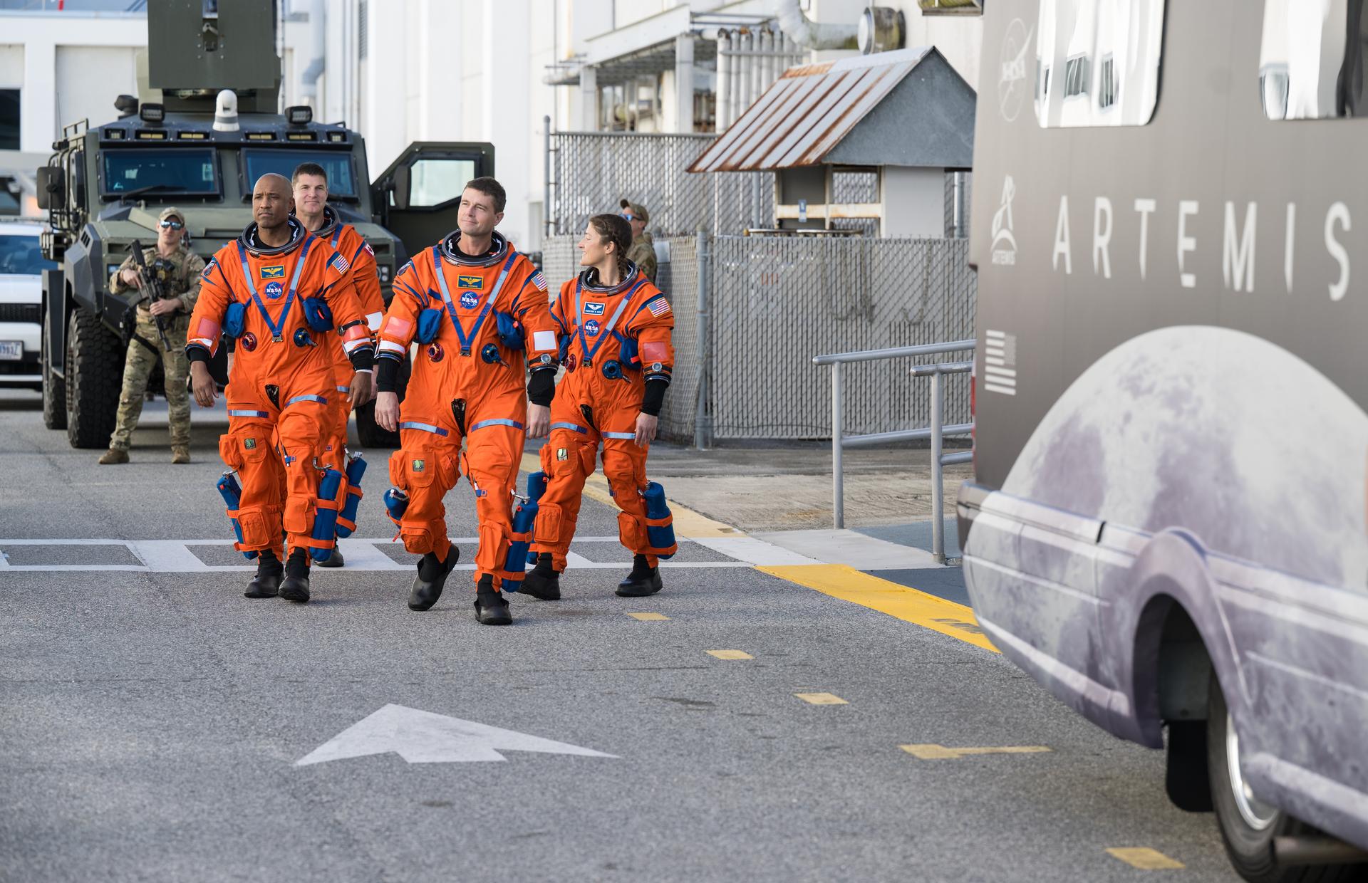 NASA astronauts Victor Glover, pilot, front left; Reid Wiseman, commander, front right; Christina Koch, mission specialist, back right; and CSA (Canadian Space Agency) astronaut Jeremy Hansen, mission specialist, back left, are seen as they depart the Neil A. Armstrong Operations and Checkout Building to board their Orion spacecraft atop NASA’s Space Launch System rocket inside the Vehicle Assembly Building as part of the Artemis II countdown demonstration test, Saturday, Dec. 20, 2025, at NASA’s Kennedy Space Center in Florida. For this operation, the Artemis II crew and launch teams are simulating the launch day timeline including suit-up, walkout, and spacecraft ingress and egress. Through the Artemis campaign, NASA will send astronauts to explore the Moon for scientific discovery, economic benefits, and to build the foundation for the first crewed missions to Mars, for the benefit of all. Photo Credit: (NASA/Aubrey Gemignani)