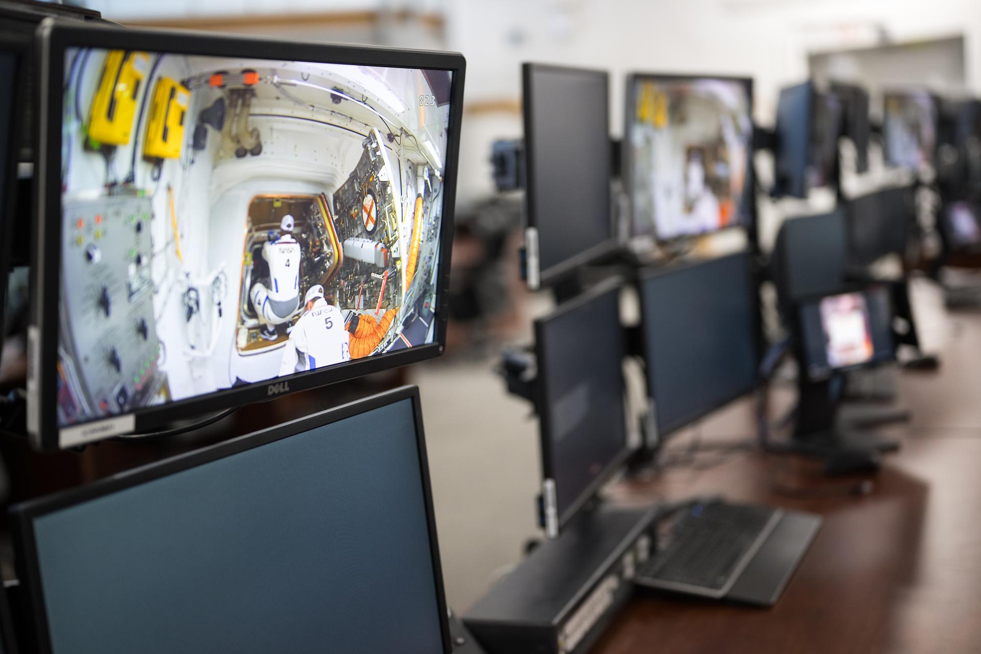 Teams monitor the progress of a Countdown Demonstration Test with Artemis II crewmembers NASA astronauts Reid Wiseman, commander; Victor Glover, pilot; Christina Koch, mission specialist; and CSA (Canadian Space Agency) astronaut Jeremy Hansen, mission specialist onboard their Orion spacecraft from Firing Room 2 of the Rocco A. Petrone Launch Control Center, Saturday, Dec. 20, 2025, at NASA’s Kennedy Space Center in Florida. For this operation, the Artemis II crew and launch teams are simulating the launch day timeline including suit-up, walkout, and spacecraft ingress and egress.  Through the Artemis campaign, NASA will send astronauts to explore the Moon for scientific discovery, economic benefits, and to build the foundation for the first crewed missions to Mars, for the benefit of all. Photo Credit: (NASA/Aubrey Gemignani)