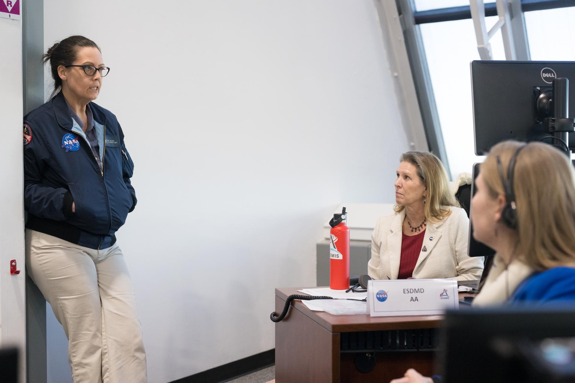 Emily Nelson, NASA's chief flight director, Lori Glaze, acting associate administrator for NASA's Exploration Systems Development Mission Directorate, and Stephanie Schierholz, chief of staff for NASA's Exploration Systems Development Mission Directorate, discuss the progress of a Countdown Demonstration Test with Artemis II crewmembers NASA astronauts Reid Wiseman, commander; Victor Glover, pilot; Christina Koch, mission specialist; and CSA (Canadian Space Agency) astronaut Jeremy Hansen, mission specialist onboard their Orion spacecraft from Firing Room 2 of the Rocco A. Petrone Launch Control Center, Saturday, Dec. 20, 2025, at NASA’s Kennedy Space Center in Florida. For this operation, the Artemis II crew and launch teams are simulating the launch day timeline including suit-up, walkout, and spacecraft ingress and egress.  Through the Artemis campaign, NASA will send astronauts to explore the Moon for scientific discovery, economic benefits, and to build the foundation for the first crewed missions to Mars, for the benefit of all. Photo Credit: (NASA/Aubrey Gemignani)