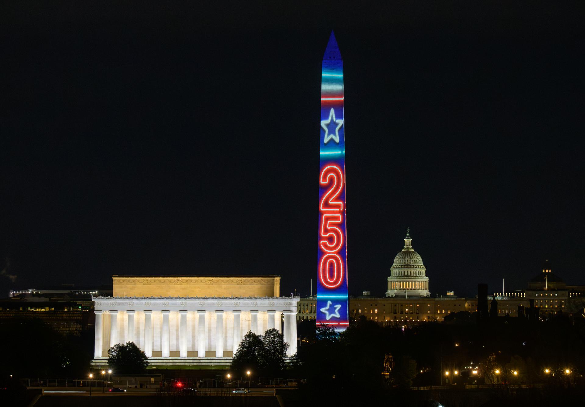The Washington Monument is lit as part of an event to kick off the nation's 250th birthday year, Wednesday, Dec. 31, 2025, in Washington. Photo Credit: (NASA/Bill Ingalls)