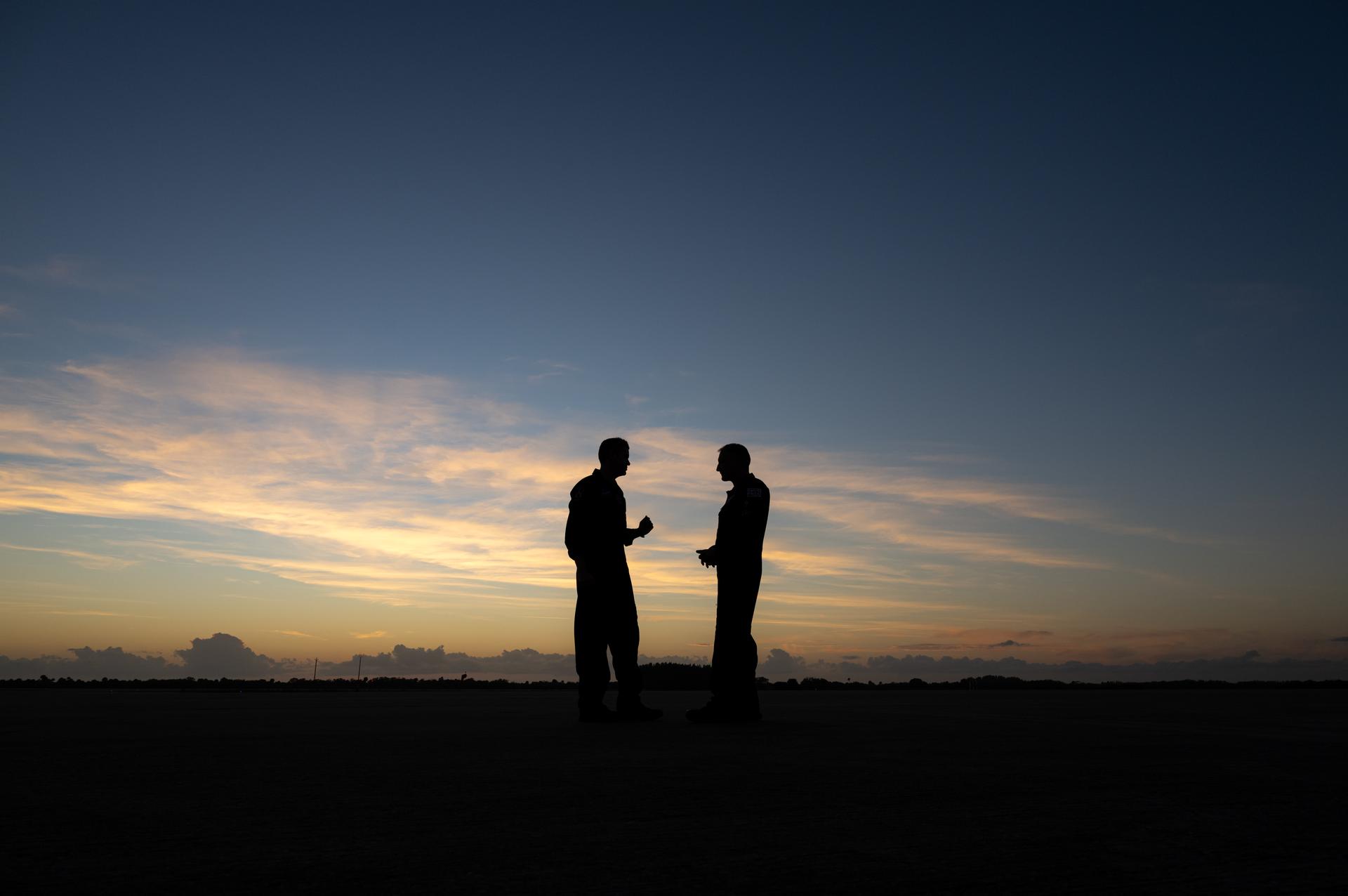 NASA Administrator Jared Isaacman, left, and Sean Gustafson, senior advisor to the administrator, right, are seen at sunset following a formation flight in Isaacman's personal F-5 aircraft, Monday, Jan. 5, 2026, at NASA’s Kennedy Space Center in Florida. Photo Credit: (NASA/John Kraus)