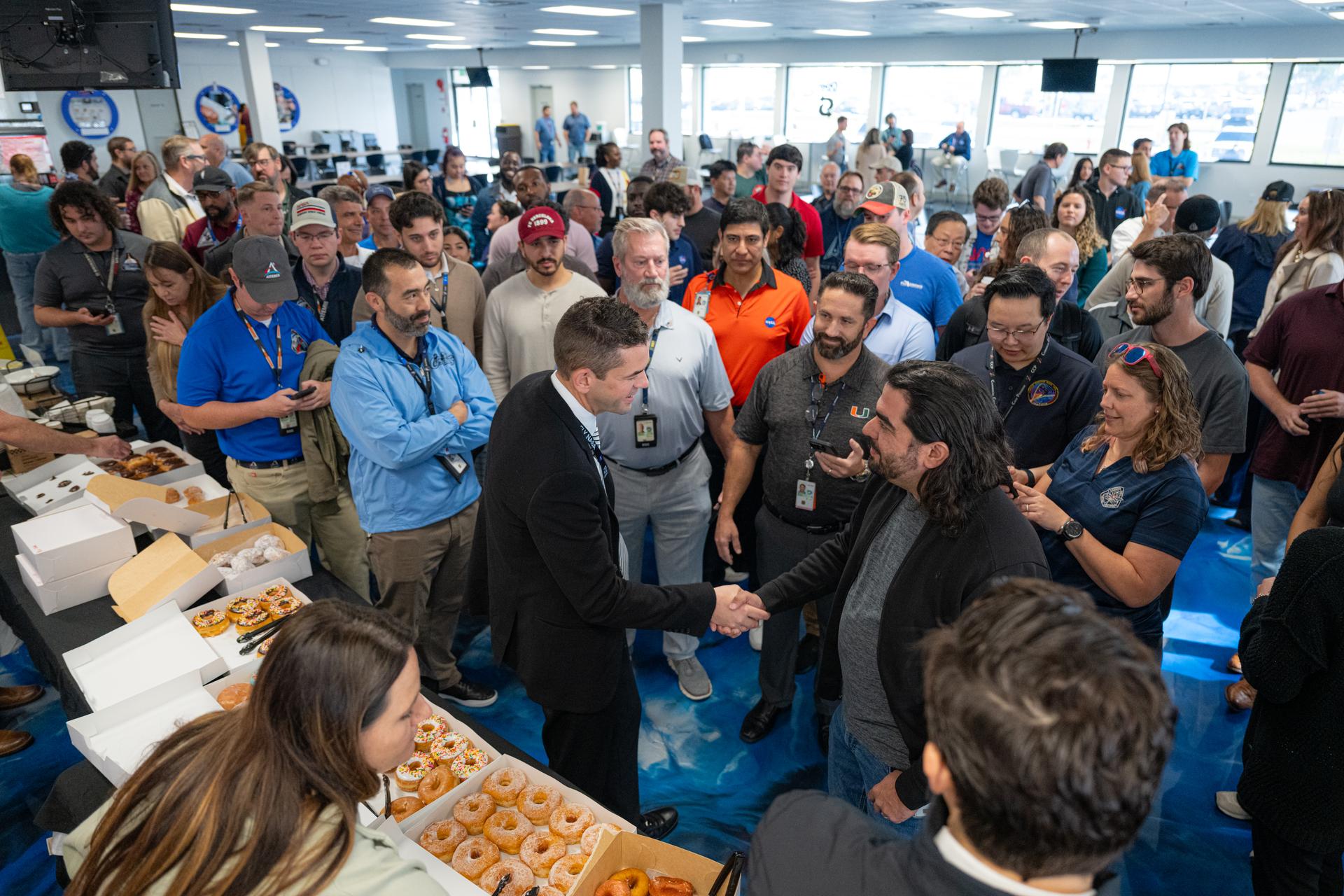NASA Administrator Jared Isaacman, center, greets members of the workforce, Tuesday, Jan. 13, 2026, at NASA’s Kennedy Space Center in Florida. Kennedy marks the fourth stop in Isaacman’s roadshow to visit NASA facilities and engage directly with the agency’s workforce. Photo Credit: (NASA/John Kraus)
