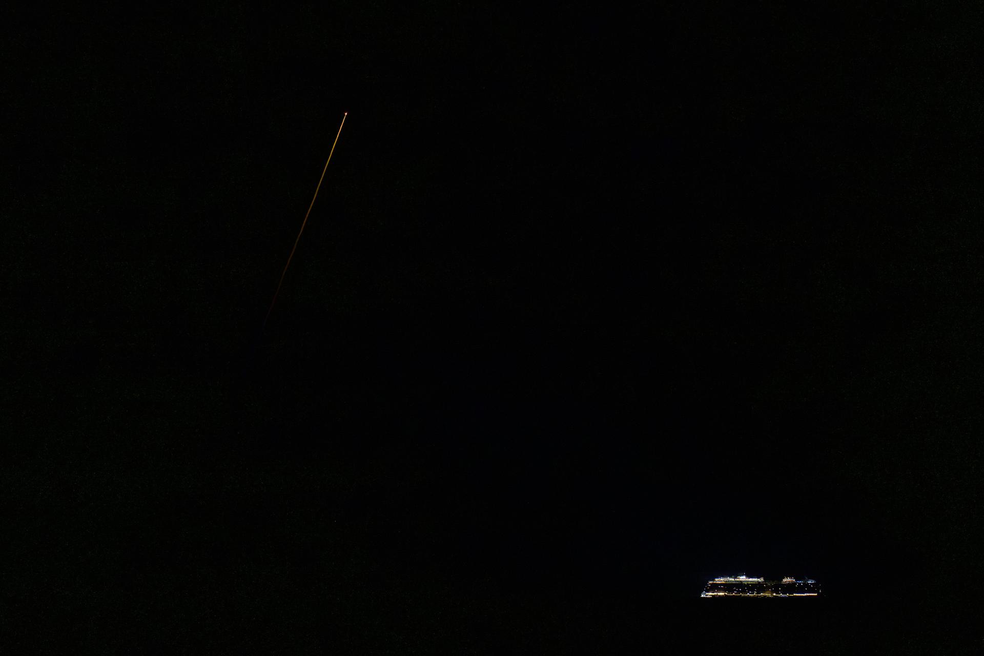 A cruise ship is seen off in the disctance as the SpaceX Crew Dragon Endeavour spacecraft lands with NASA astronauts Zena Cardman, Mike Fincke, JAXA (Japan Aerospace Exploration Agency) astronaut Kimiya Yui, and Roscosmos cosmonaut Oleg Platonov aboard in the Pacific Ocean off the coast of San Diego, Calif., Thursday, Jan. 15, 2026. Cardman, Fincke, Yui, Platonov are returning after 167 days in space as part of Expedition 74 aboard the International Space Station. Photo Credit: (NASA/Bill Ingalls)