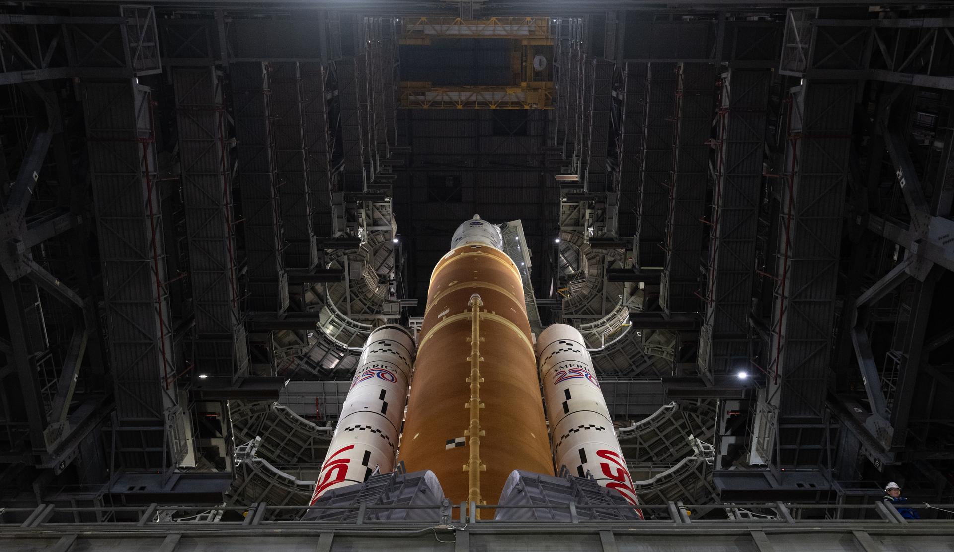 NASA’s Artemis II SLS (Space Launch System) rocket and Orion spacecraft, secured to the mobile launcher, is seen  inside the Vehicle Assembly building as preparations continue for rollout to Launch Pad 39B, Friday, Jan. 16, 2026, at NASA’s Kennedy Space Center in Florida. NASA’s Artemis II flight test will take Commander Reid Wiseman, Pilot Victor Glover, and Mission Specialist Christina Koch from NASA, and Mission Specialist Jeremy Hansen from the CSA (Canadian Space Agency), around the Moon and back to Earth no later than April 2026. Photo Credit: (NASA/Joel Kowsky)
