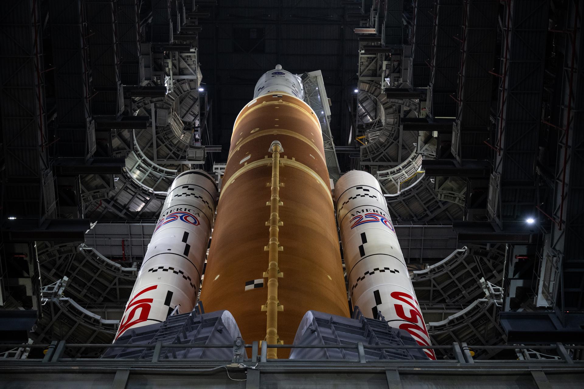 NASA’s Artemis II SLS (Space Launch System) rocket and Orion spacecraft, secured to the mobile launcher, is seen  inside the Vehicle Assembly building as preparations continue for rollout to Launch Pad 39B, Friday, Jan. 16, 2026, at NASA’s Kennedy Space Center in Florida. NASA’s Artemis II flight test will take Commander Reid Wiseman, Pilot Victor Glover, and Mission Specialist Christina Koch from NASA, and Mission Specialist Jeremy Hansen from the CSA (Canadian Space Agency), around the Moon and back to Earth no later than April 2026. Photo Credit: (NASA/Joel Kowsky)