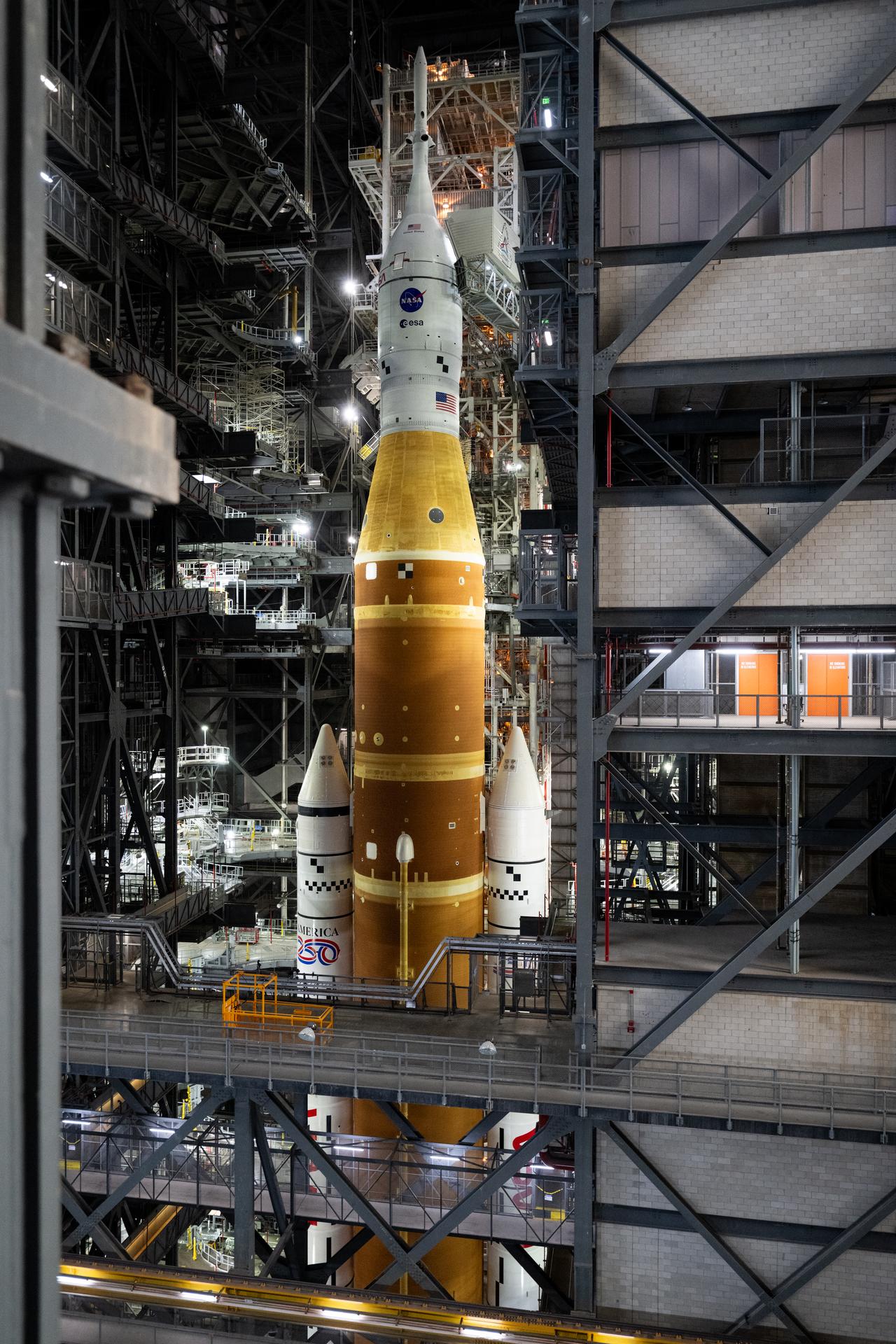 NASA’s Artemis II SLS (Space Launch System) rocket and Orion spacecraft, secured to the mobile launcher, is seen  inside the Vehicle Assembly building as preparations continue for rollout to Launch Pad 39B, Friday, Jan. 16, 2026, at NASA’s Kennedy Space Center in Florida. NASA’s Artemis II flight test will take Commander Reid Wiseman, Pilot Victor Glover, and Mission Specialist Christina Koch from NASA, and Mission Specialist Jeremy Hansen from the CSA (Canadian Space Agency), around the Moon and back to Earth no later than April 2026. Photo Credit: (NASA/Joel Kowsky)