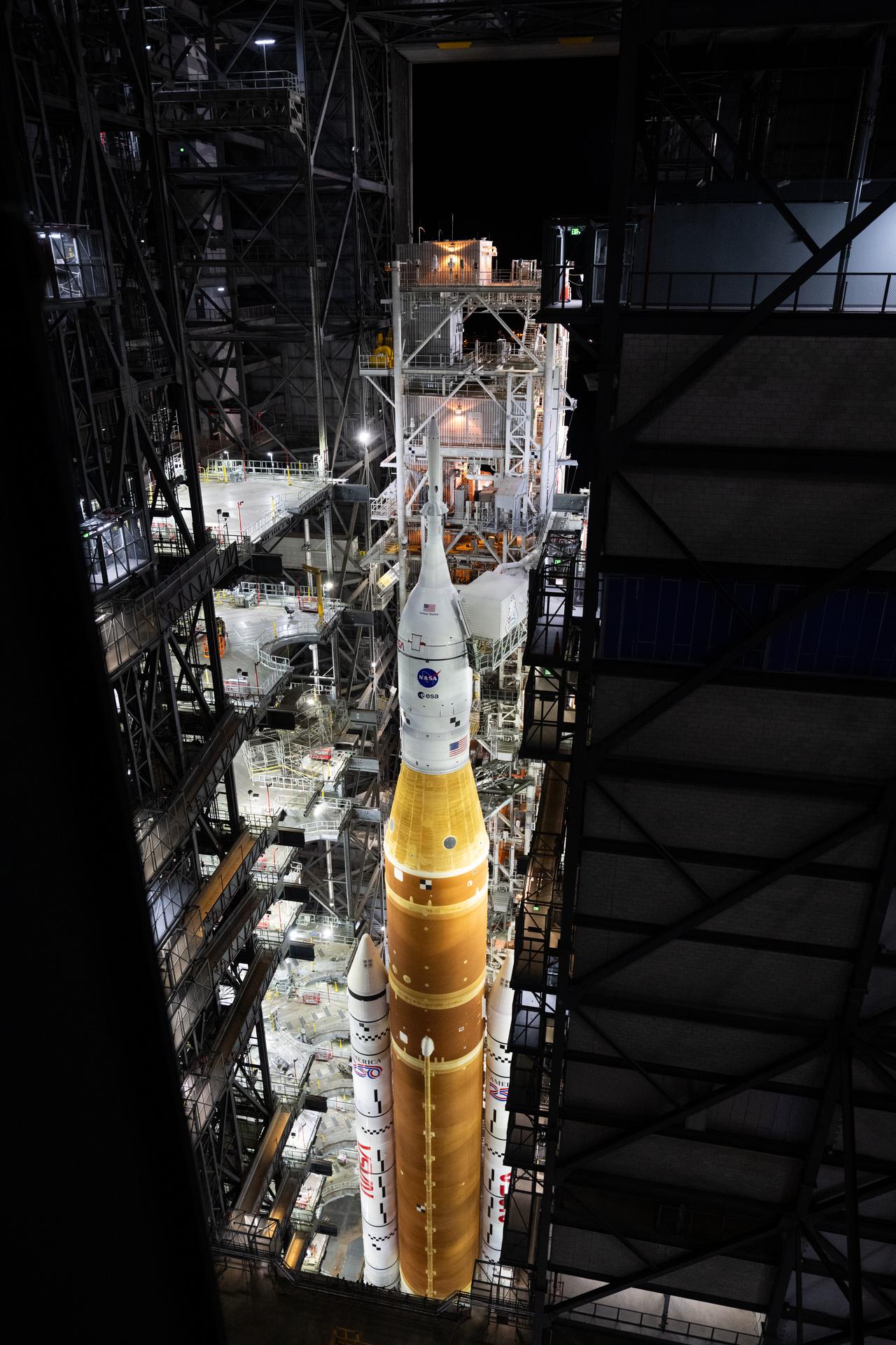 The mobile launcher with NASA’s Artemis II Space Launch System (SLS) rocket and Orion spacecraft secured to it is seen inside the Vehicle Assembly Building following the opening of the doors before rolling out to Launch Pad 39B, Saturday, Jan. 17, 2026, at NASA’s Kennedy Space Center in Florida. NASA’s Artemis II test flight will take Commander Reid Wiseman, Pilot Victor Glover, and Mission Specialist Christina Koch from NASA, and Mission Specialist Jeremy Hansen from the CSA (Canadian Space Agency), around the Moon and back to Earth no later than April 2026. Photo Credit: (NASA/Joel Kowsky)