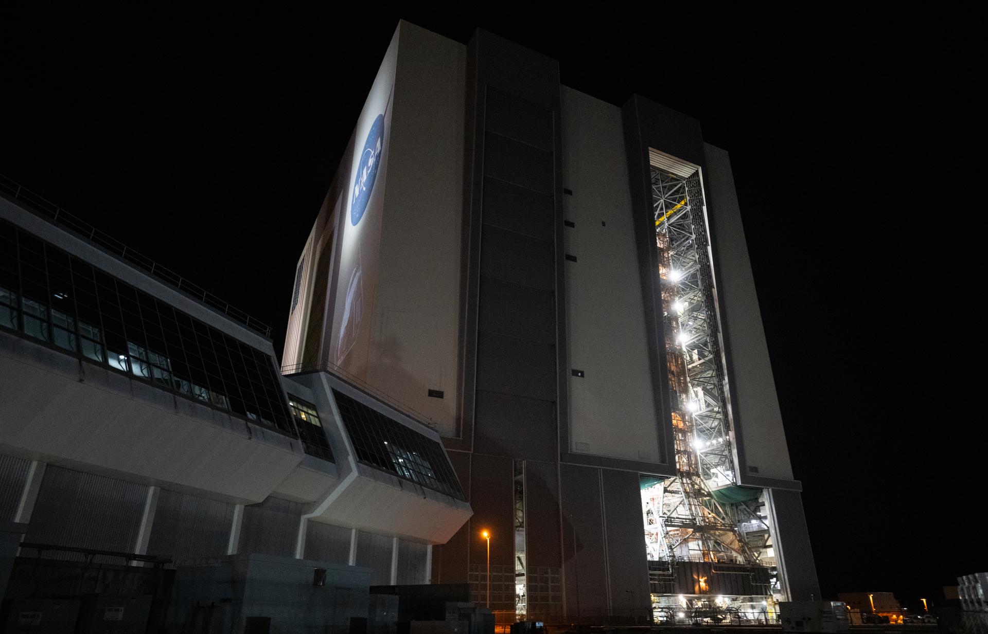 The mobile launcher with NASA’s Artemis II Space Launch System (SLS) rocket and Orion spacecraft secured to it is seen inside the Vehicle Assembly Building following the opening of the doors before rolling out to Launch Pad 39B, Saturday, Jan. 17, 2026, at NASA’s Kennedy Space Center in Florida. NASA’s Artemis II test flight will take Commander Reid Wiseman, Pilot Victor Glover, and Mission Specialist Christina Koch from NASA, and Mission Specialist Jeremy Hansen from the CSA (Canadian Space Agency), around the Moon and back to Earth no later than April 2026. Photo Credit: (NASA/Joel Kowsky)