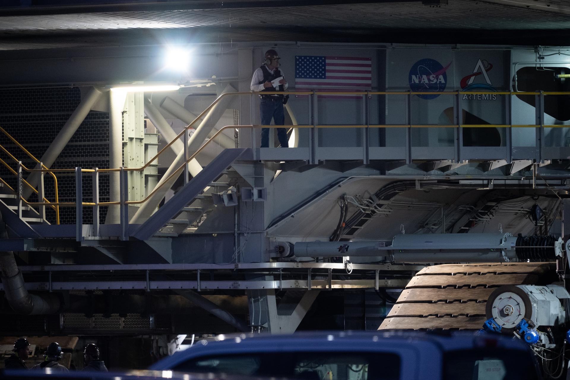 Workers are seen on crawler-transporter 2 as final preparations are made to roll NASA’s Artemis II SLS (Space Launch System) rocket and Orion spacecraft, secured to the mobile launcher, out to Launch Pad 39B, Saturday, Jan. 17, 2026, at NASA’s Kennedy Space Center in Florida. NASA’s Artemis II flight test will take Commander Reid Wiseman, Pilot Victor Glover, and Mission Specialist Christina Koch from NASA, and Mission Specialist Jeremy Hansen from the CSA (Canadian Space Agency), around the Moon and back to Earth no later than no later than April 2026. Photo Credit: (NASA/Joel Kowsky)
